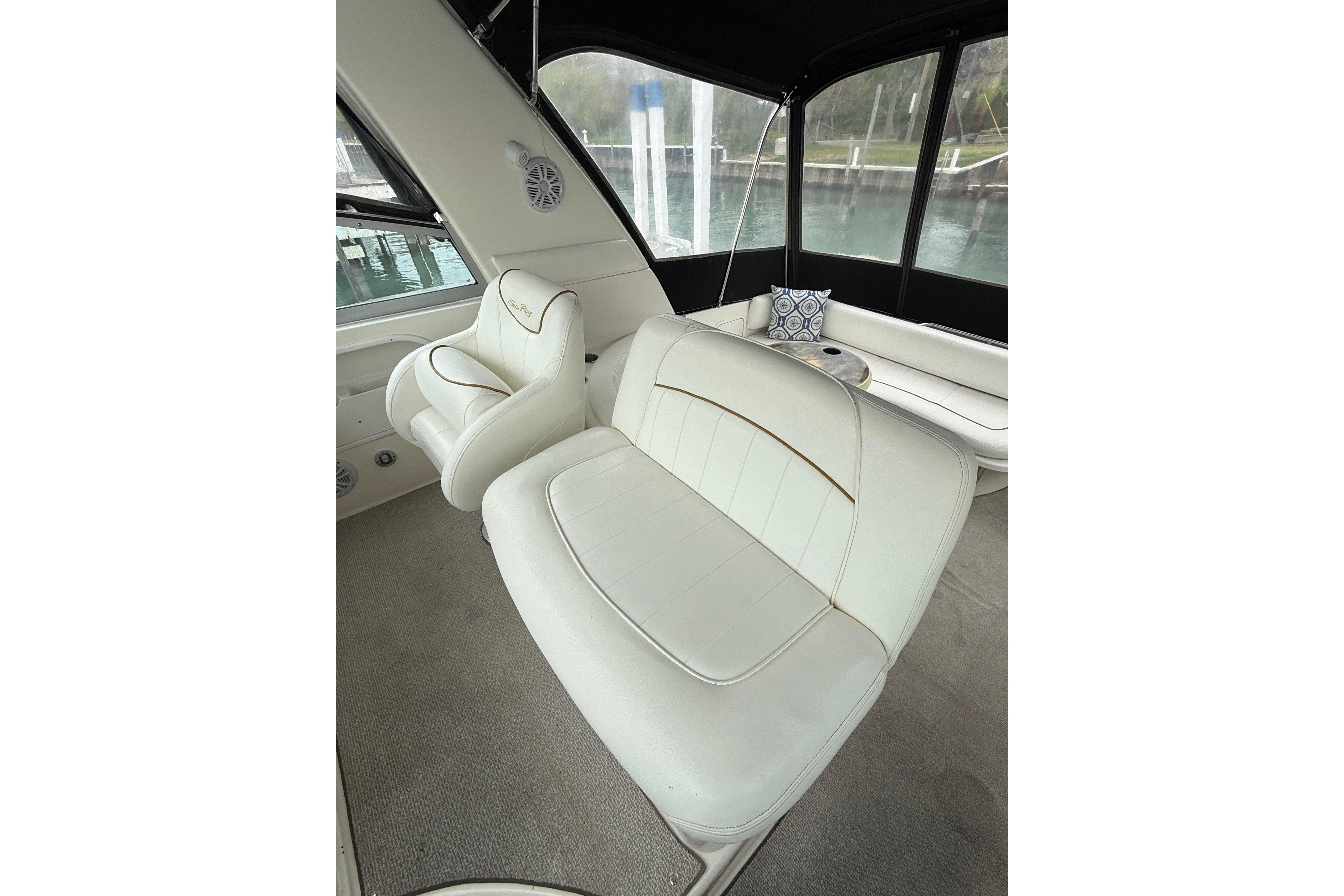 Interior of 1999 Sea Ray Sundancer 310 with white leather seating and scenic windows.