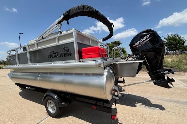 2026 Sun Tracker Bass Buggy 16 XL Select pontoon boat with Mercury outboard motor on trailer.