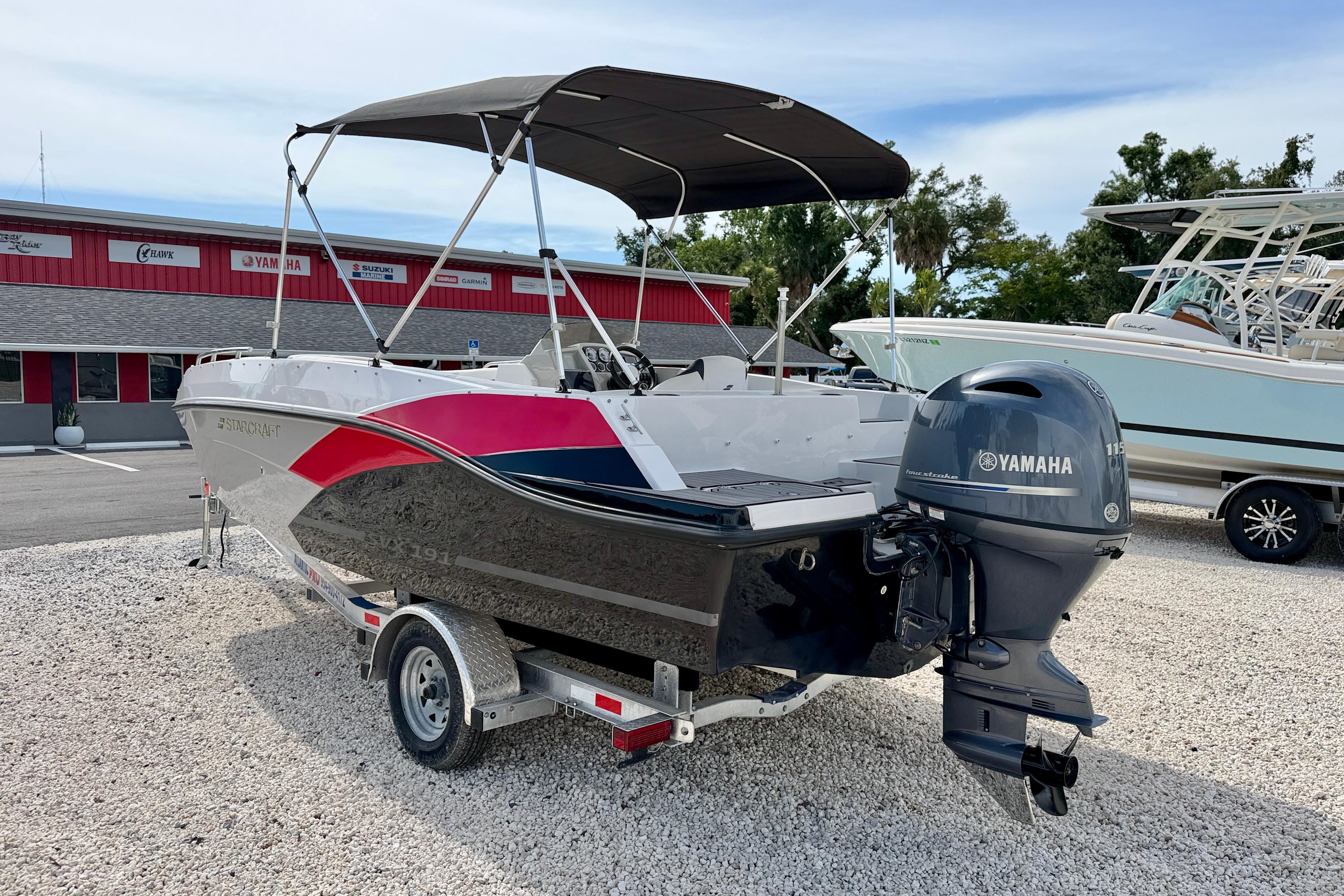 2021 Starcraft SVX 191 OB boat with Yamaha outboard motor, parked on gravel.
