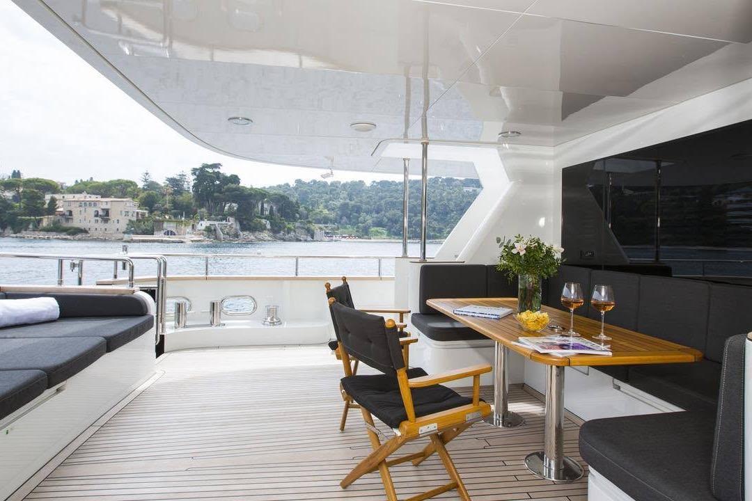 Luxurious 2014 Fifth Ocean Yachts 24m Explorer Yacht with elegant outdoor seating and scenic views.
