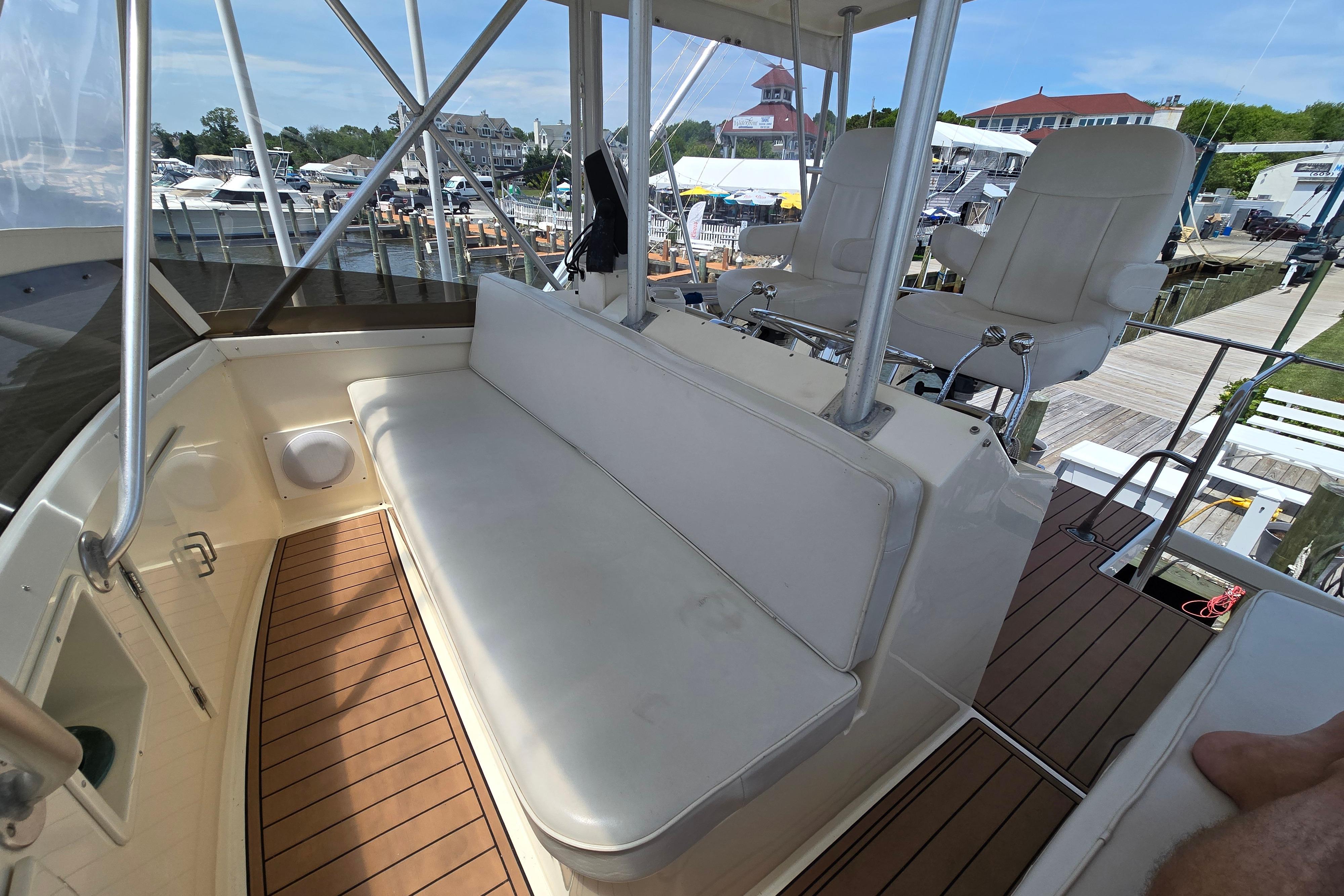 1988 Post 46 Convertible yacht interior with white seating and wooden deck at marina.