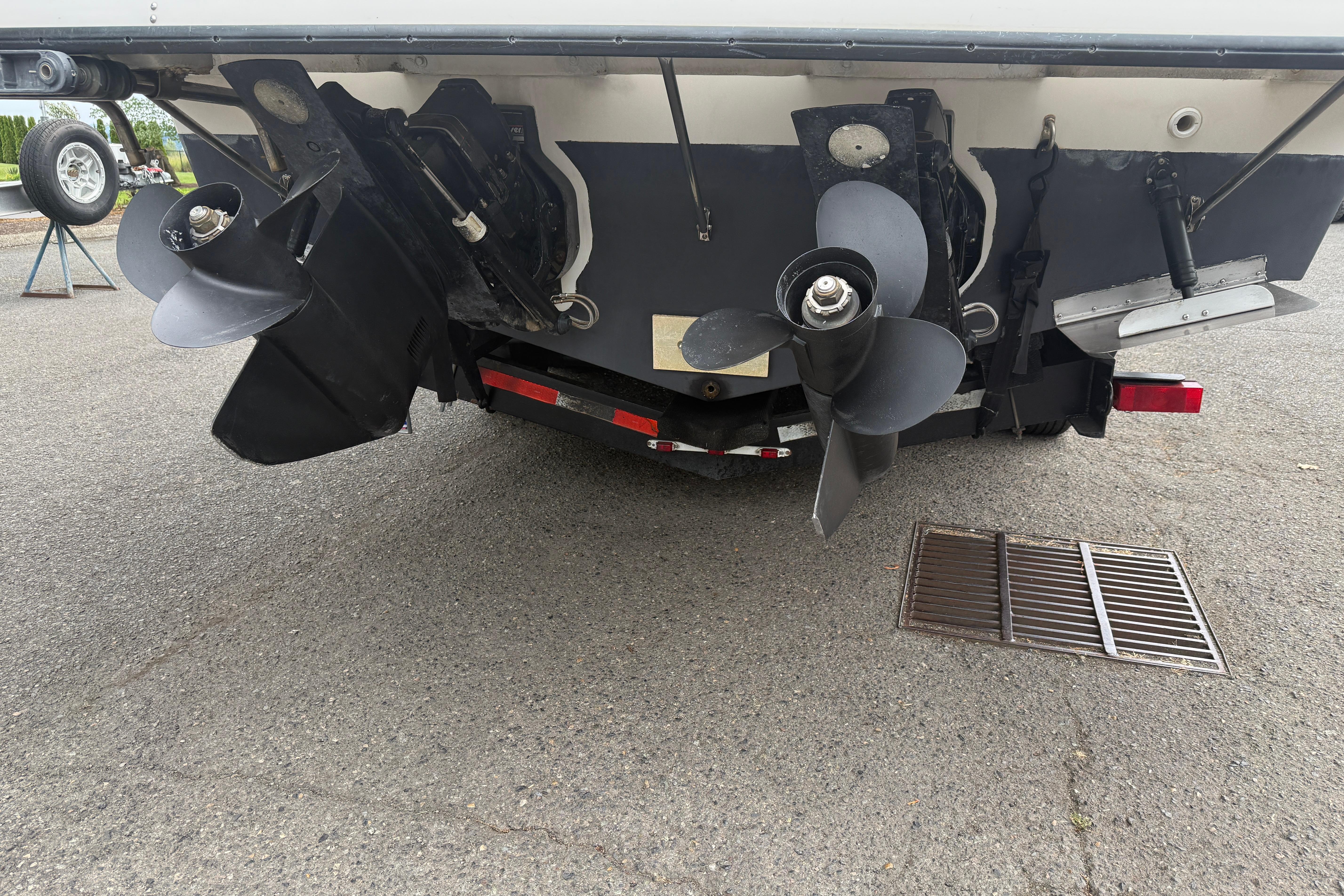 1997 Bayliner 3255 Avanti boat stern with dual propellers on a trailer.
