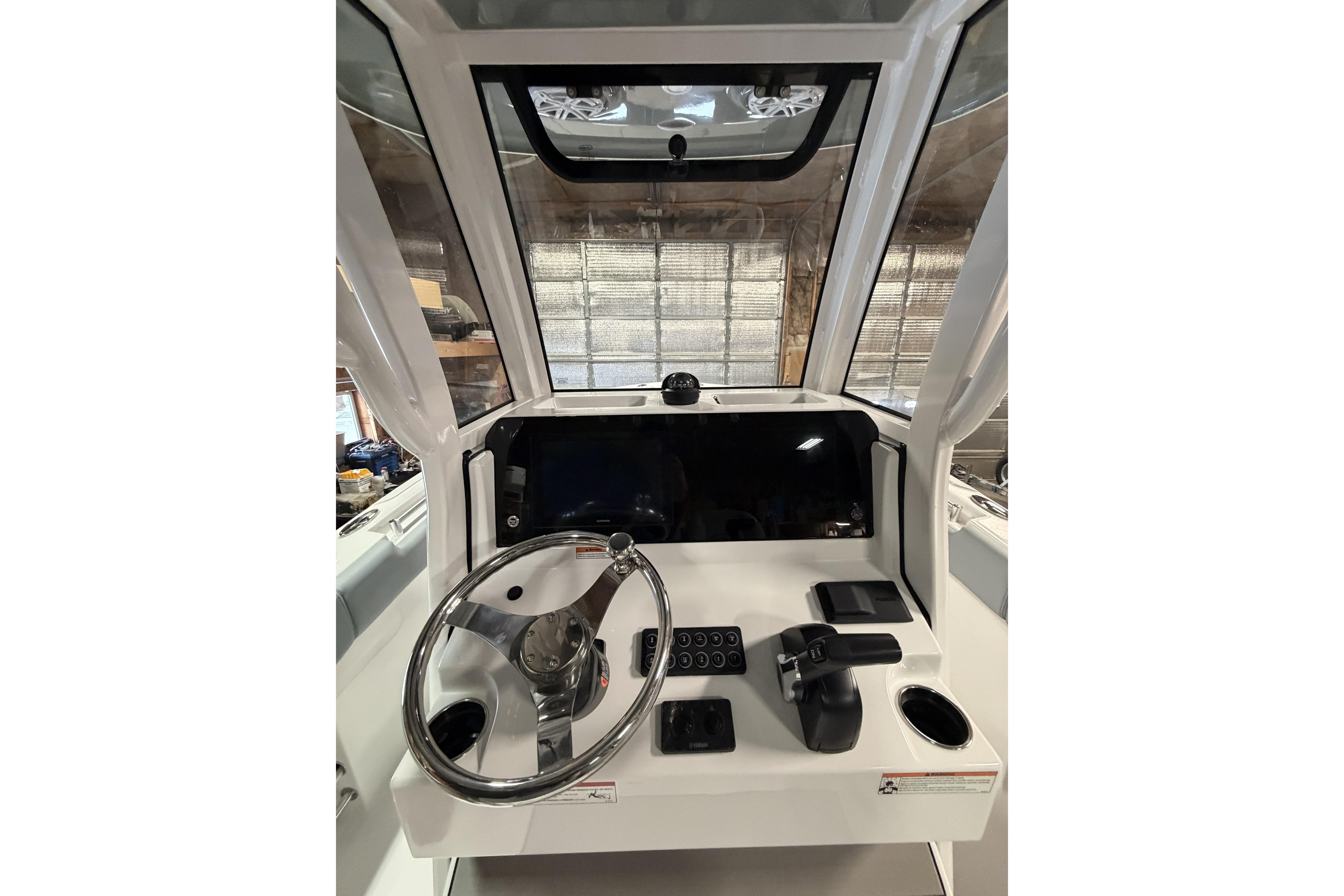 2026 Sportsman Open 232 Center Console boat dashboard with steering wheel and controls.