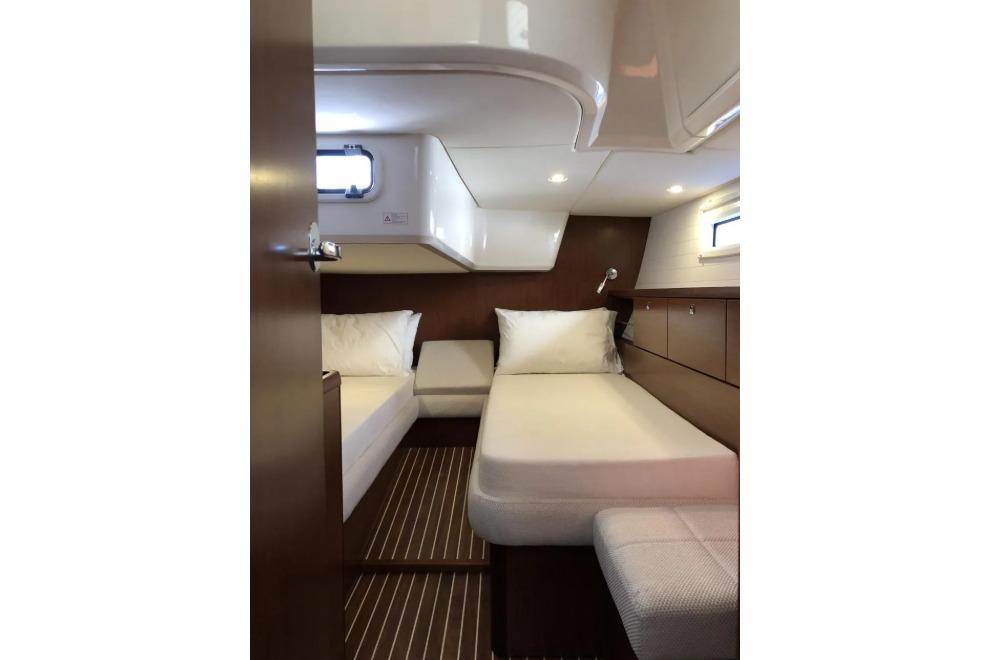 Interior cabin of 2015 Bavaria Vision 46 yacht with twin beds and wooden finish.