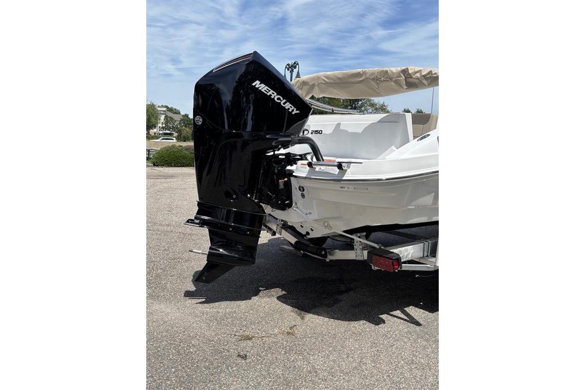 2026 Tahoe 2150 boat with Mercury outboard motor, parked on a trailer.