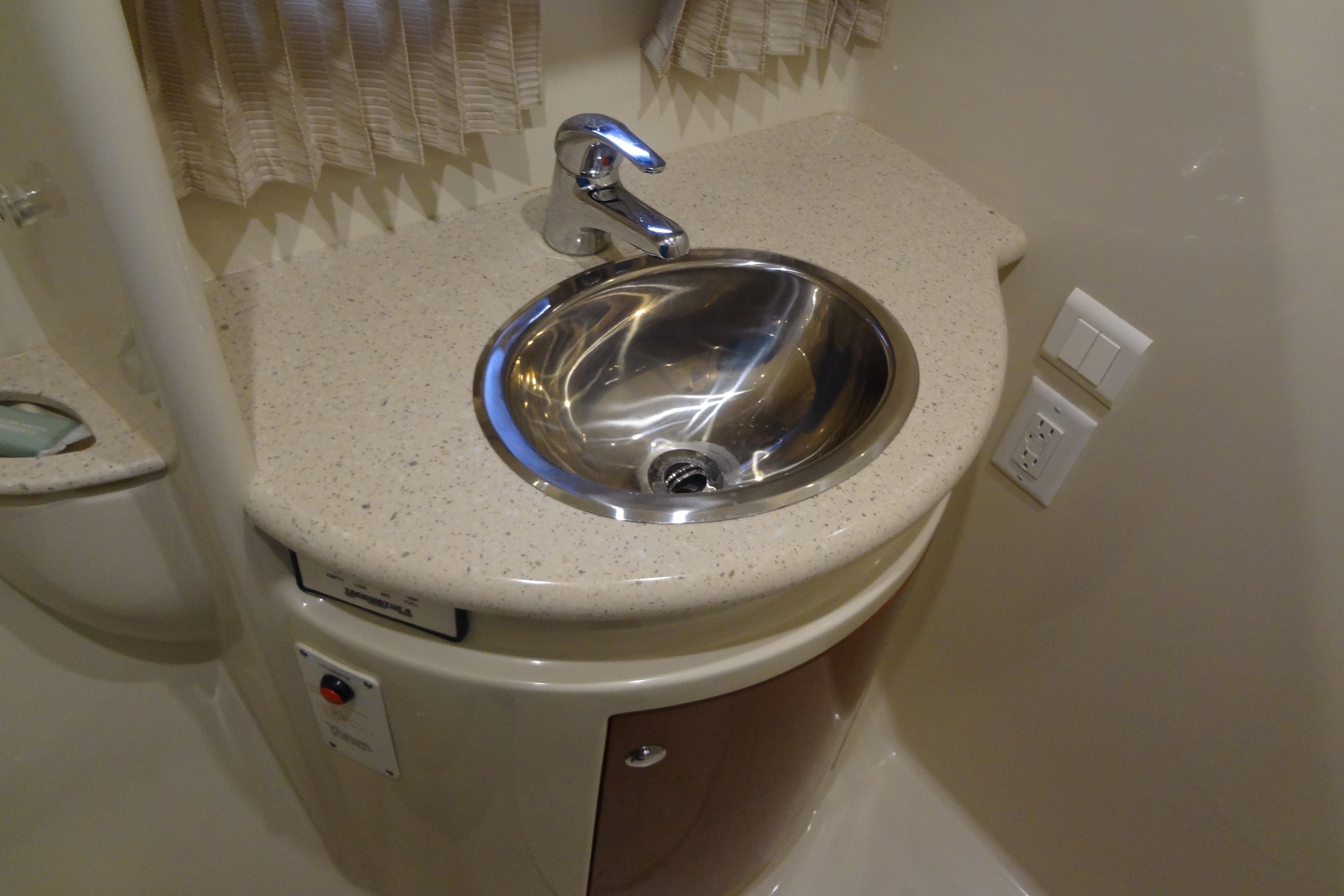 2007 Formula 34 Performance Cruiser bathroom sink with modern fixtures and beige countertop.