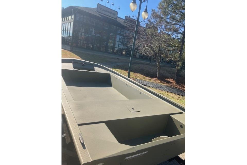 2026 Tracker Grizzly 1754 Utility boat displayed outdoors near a building.