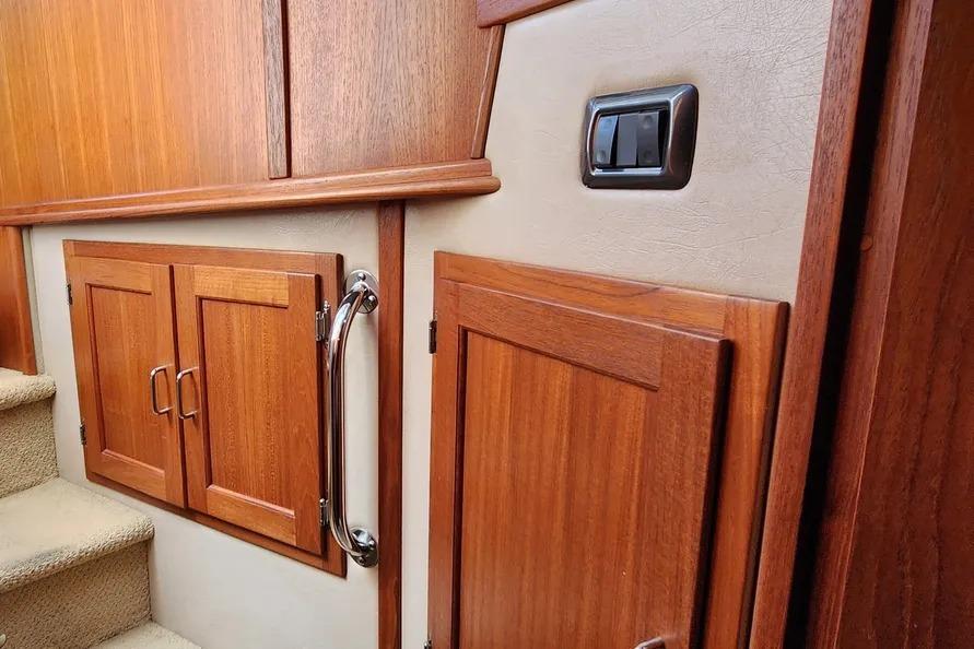 Interior of 2006 American Tug AT, featuring wooden cabinetry and carpeted stairs.