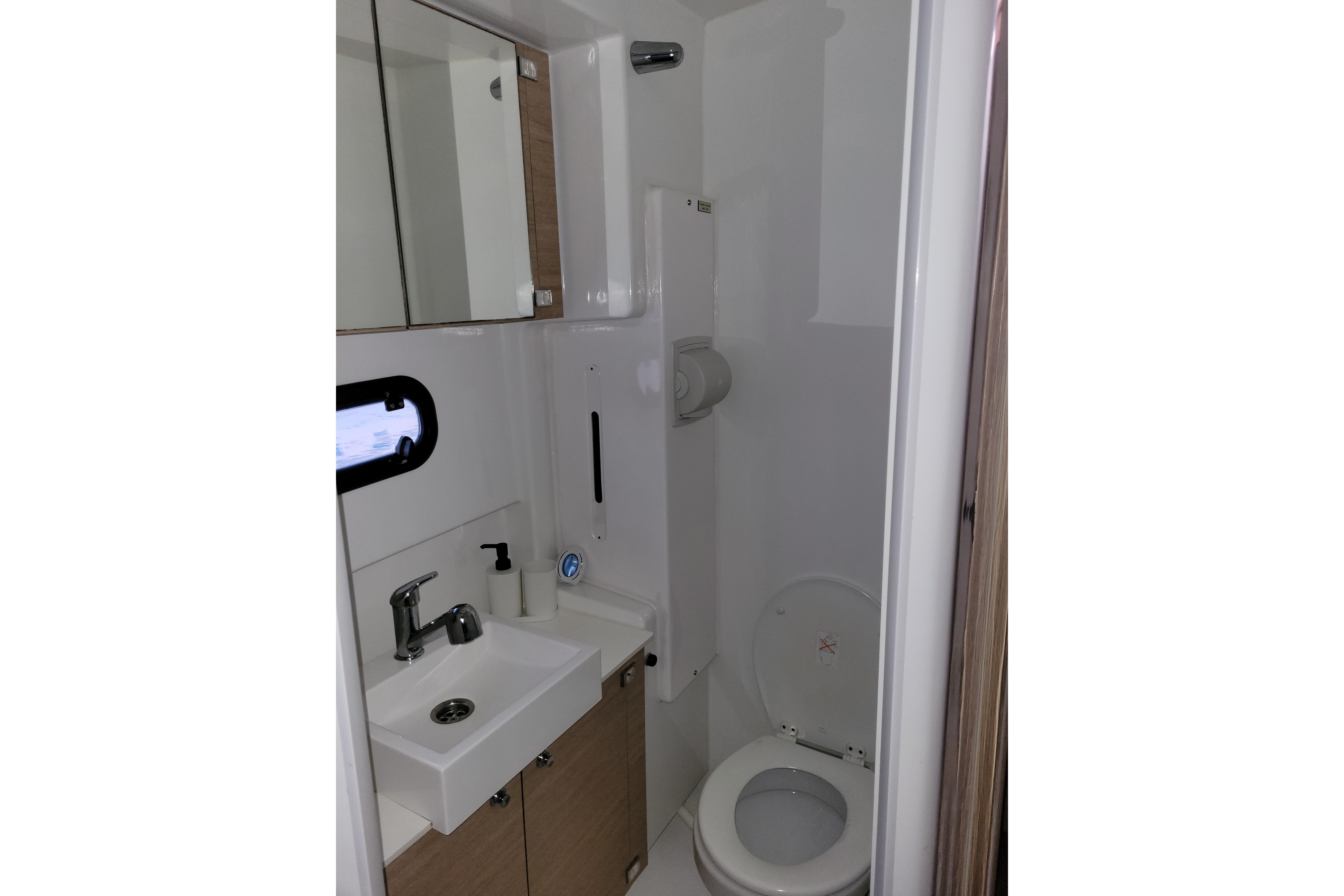 Compact bathroom in 2019 Bali 4.3 model yacht with sink, mirror, and toilet.