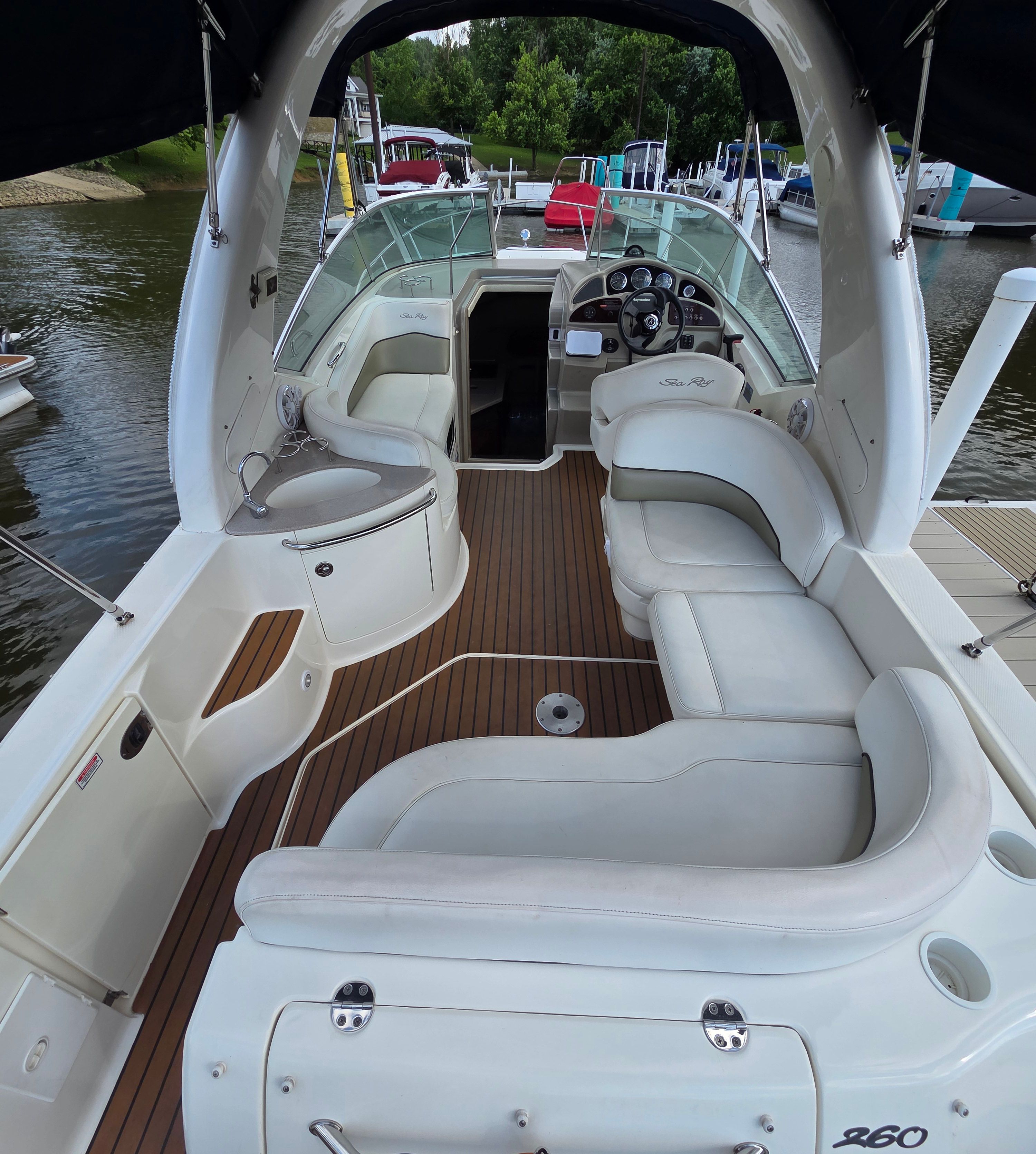 2005 Sea Ray Sundancer 260 with sleek interior and comfortable seating at the dock.