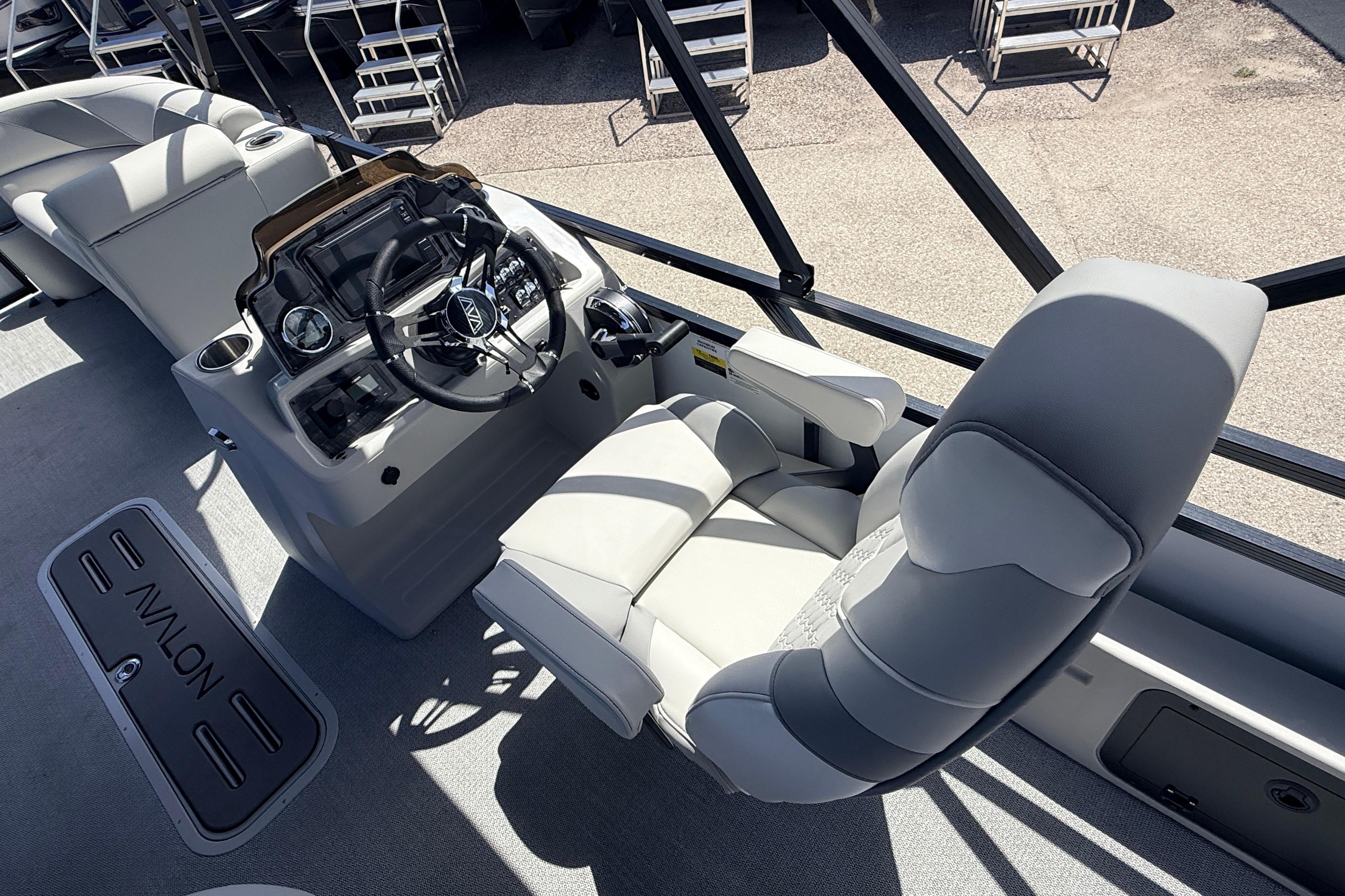 Interior view of 2026 Avalon 2385 Venture 85 Tri Toon boat with steering console.
