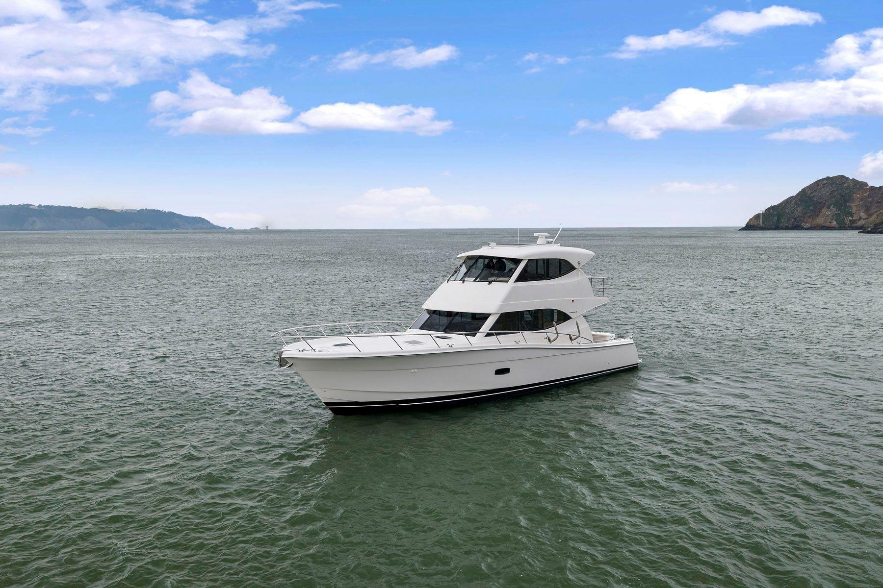2014 Maritimo M50 yacht cruising on open water under a clear blue sky.