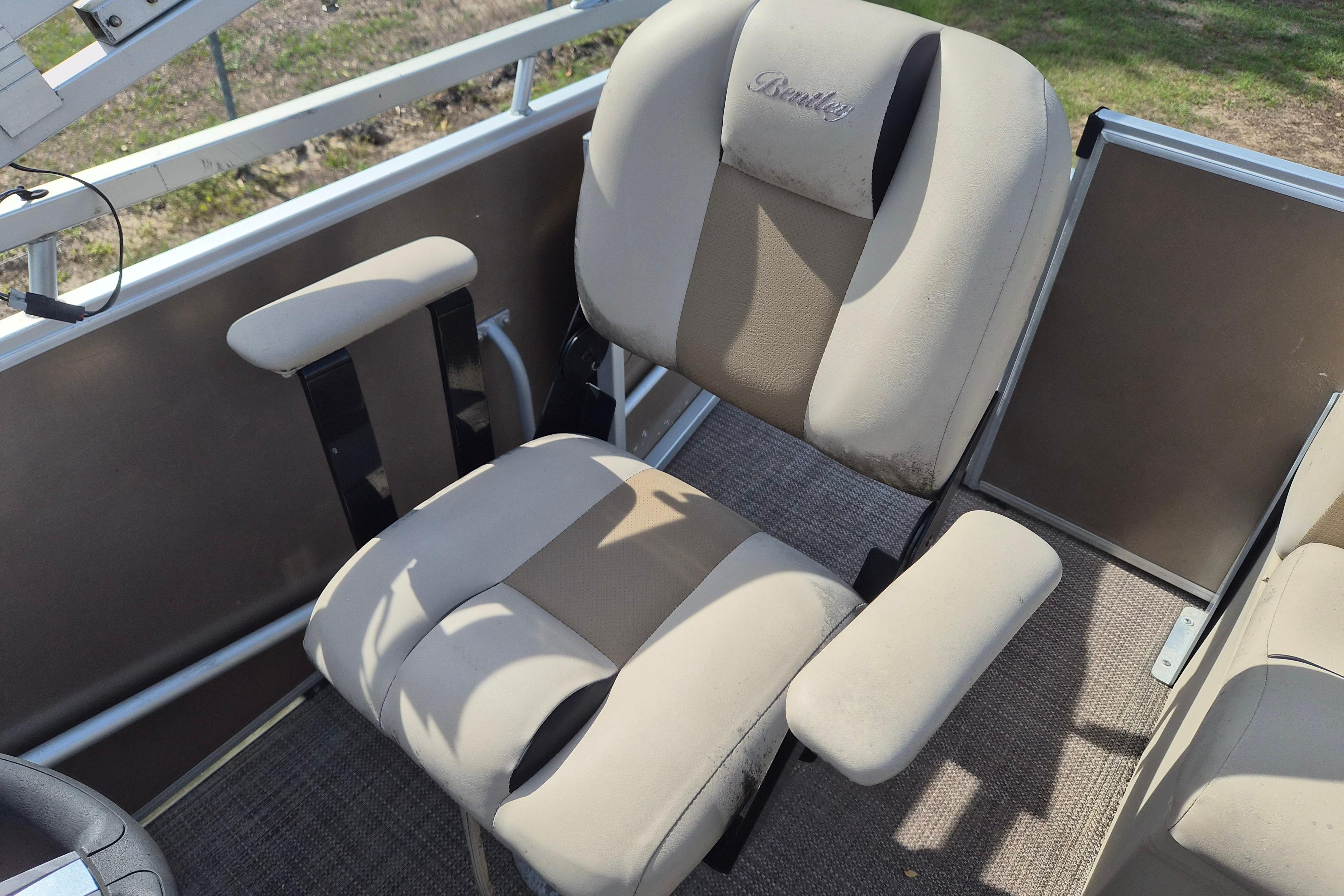 2004 Bentley Pontoons 180 CRUISE boat seats with beige upholstery and armrests.