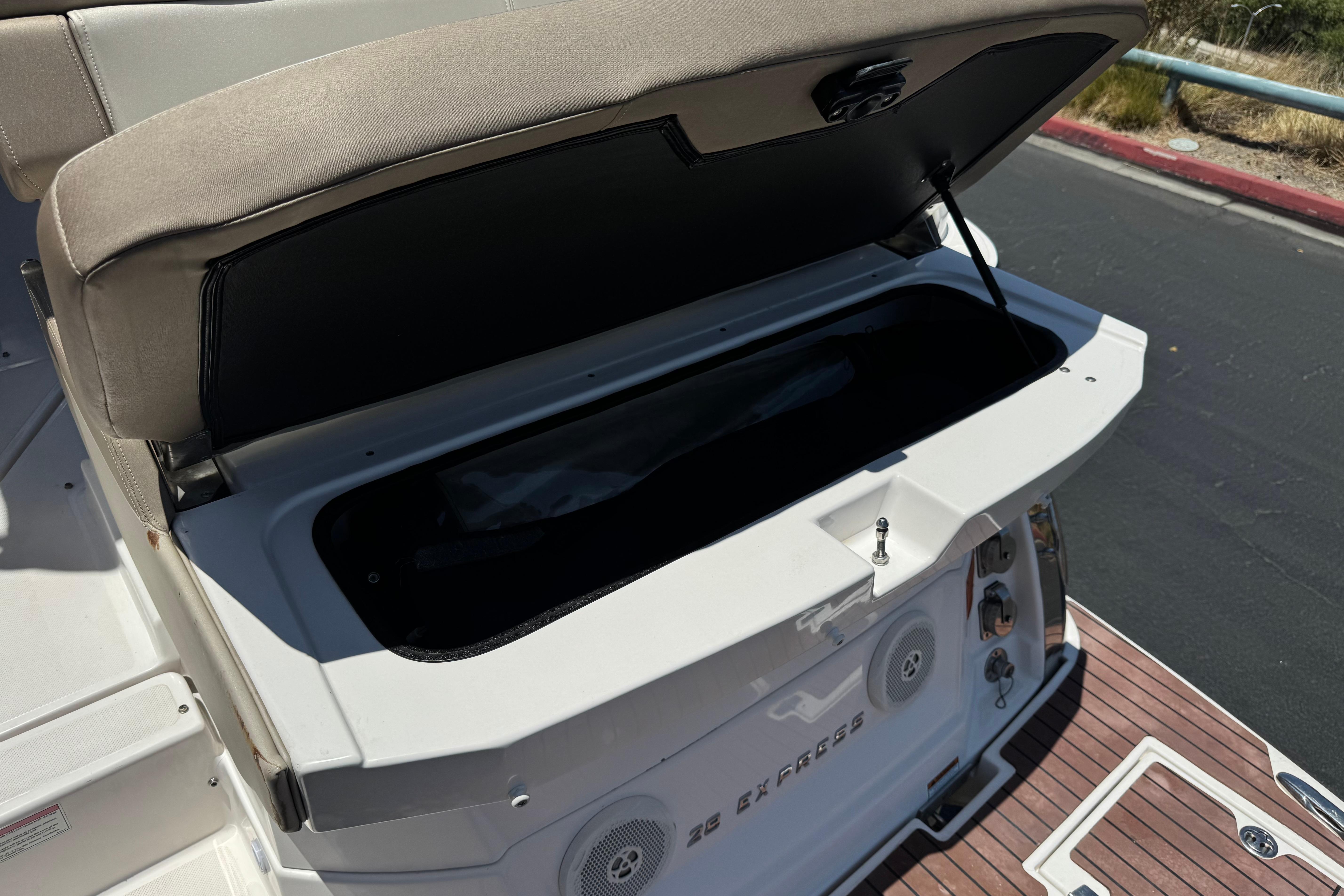 Open storage compartment on a 2013 Regal 28 Express boat deck.