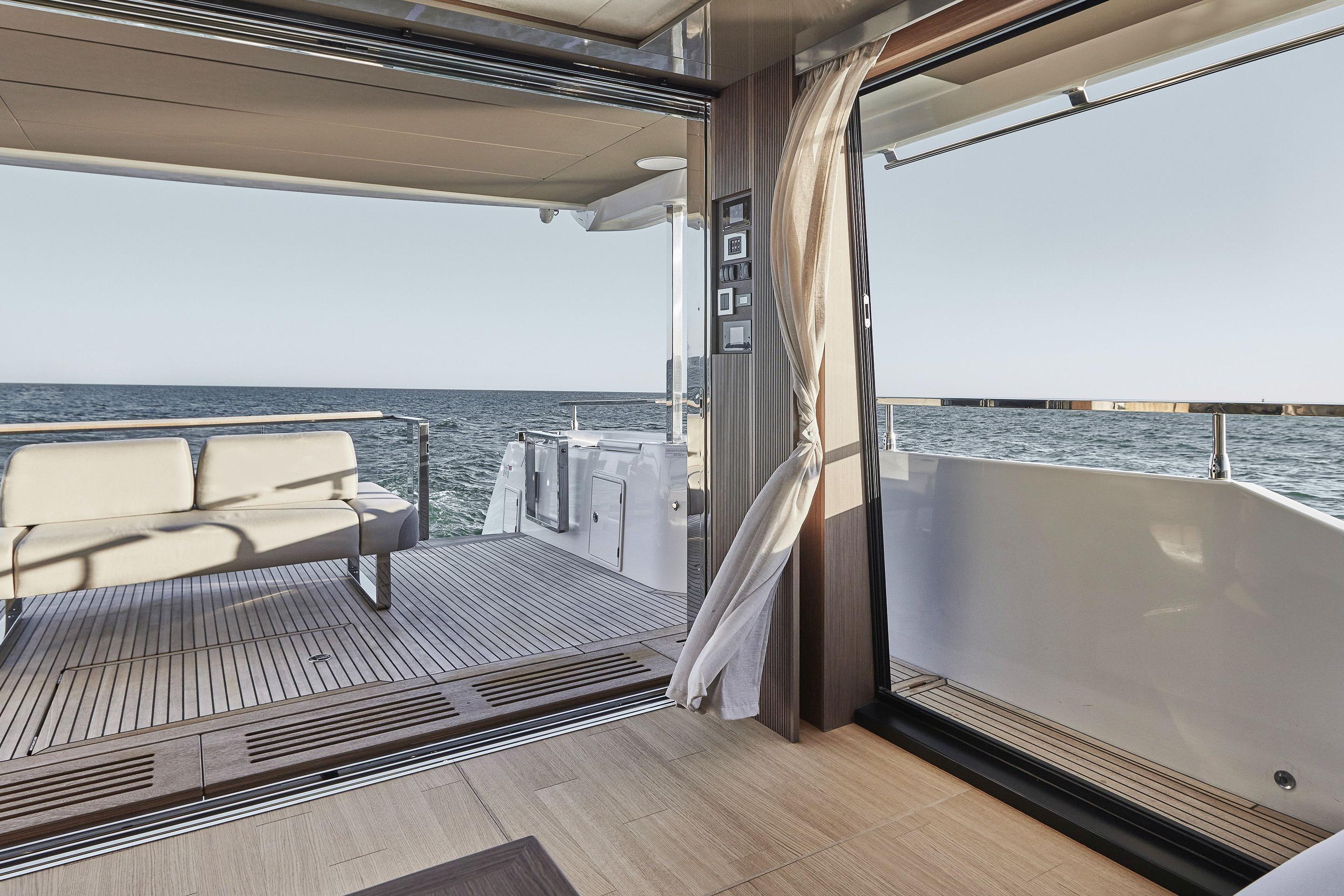 Luxurious 2026 Prestige X60 yacht interior with ocean view and elegant seating area.