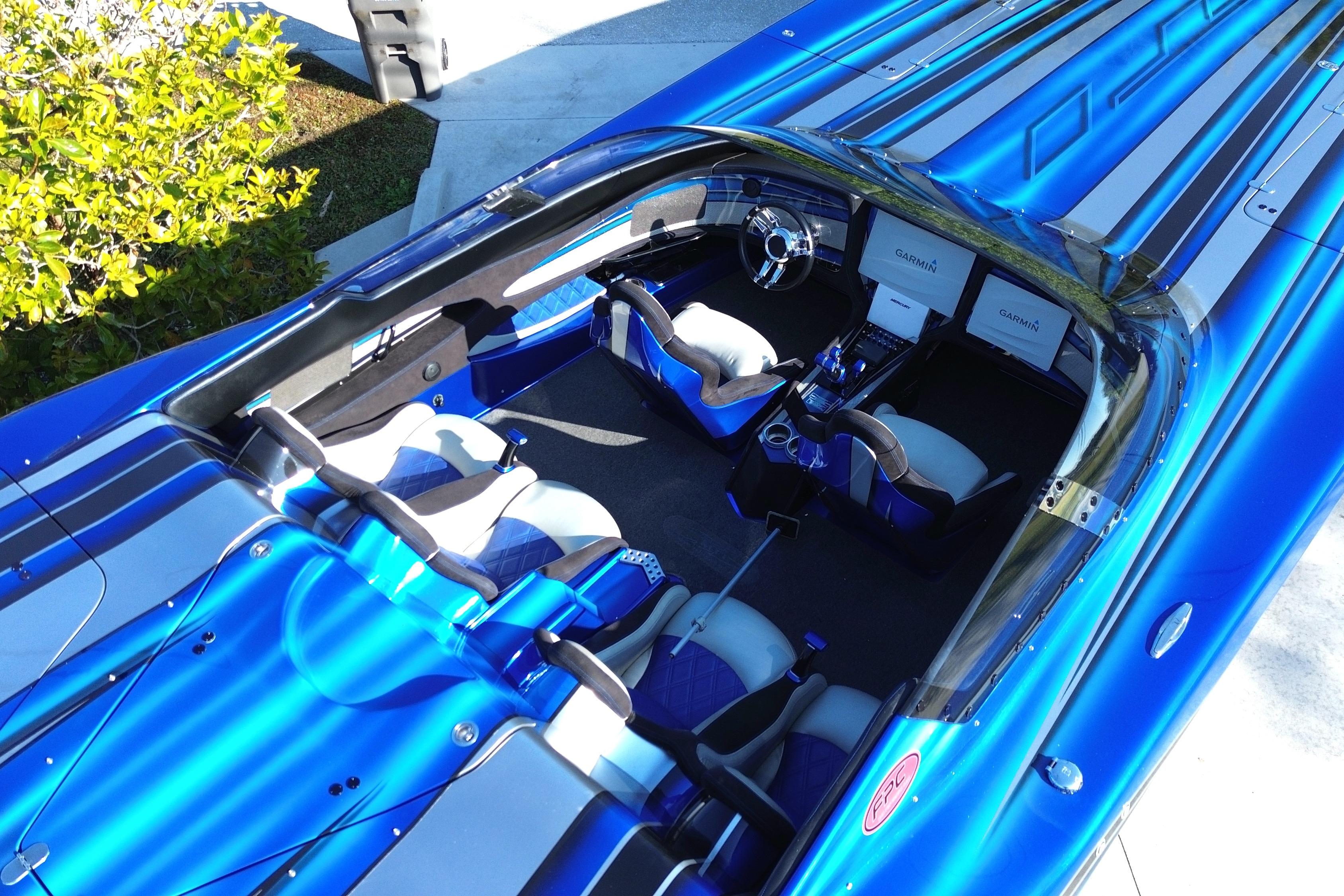 2016 MTI 44 RP powerboat interior with blue and white seating, dual Garmin displays.