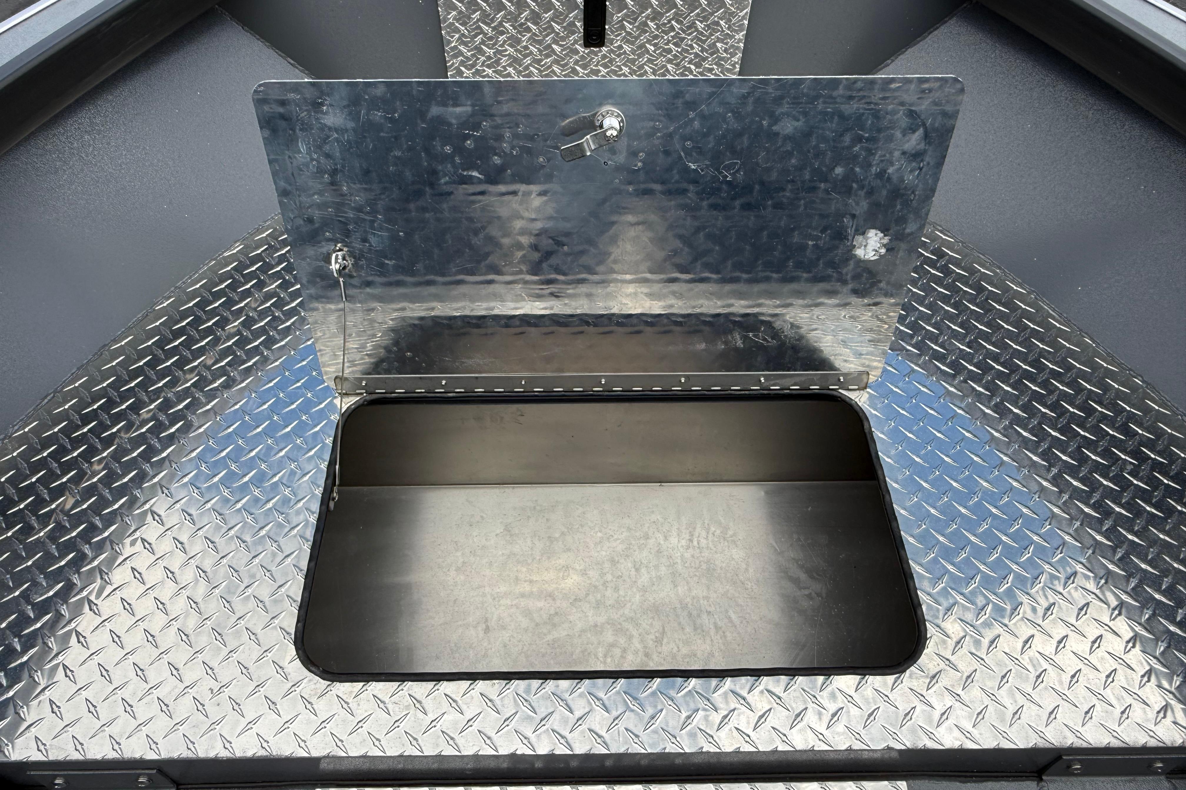 Alumaweld Free Drifter 20 (2026) boat storage compartment with diamond plate flooring.