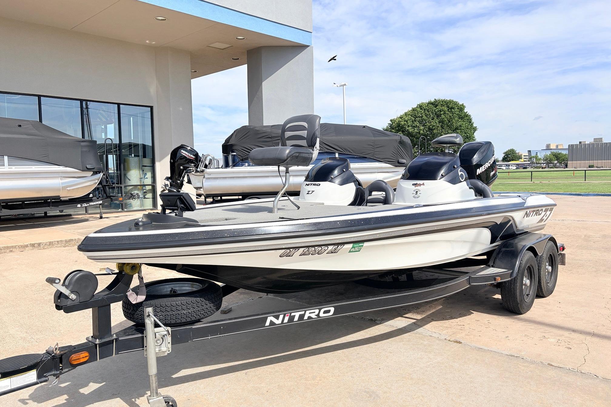 2011 Nitro Z-7 boat on trailer, parked outside dealership under clear sky.
