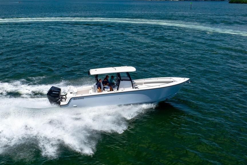 2027 Reef Runner 340 boat cruising on open water, showcasing sleek design and performance.