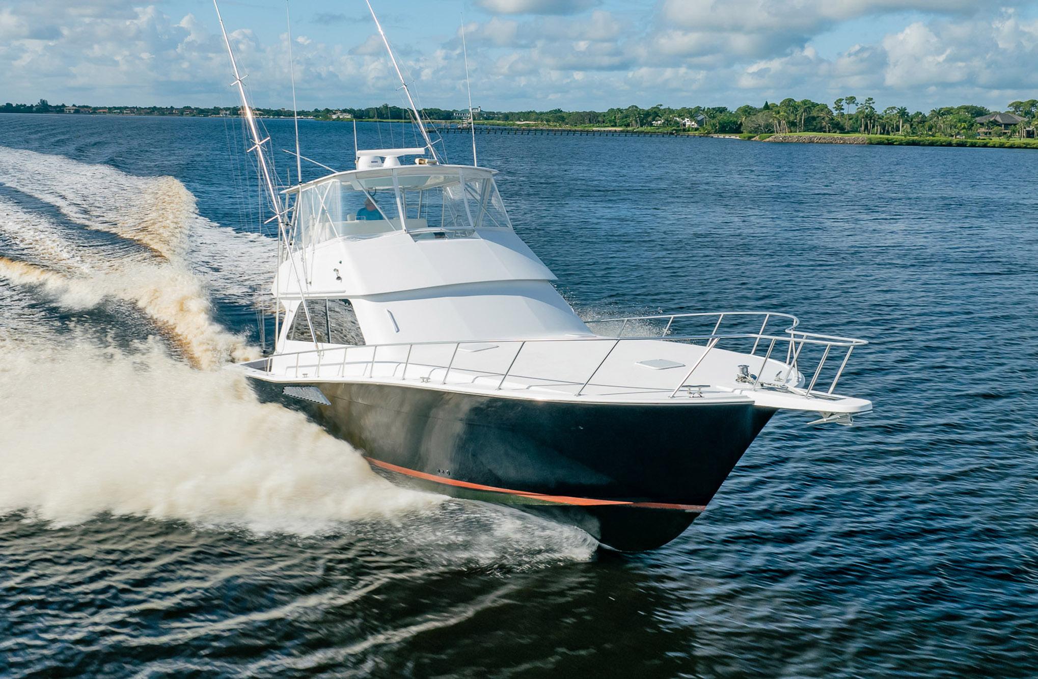 Viking 50 Conv Sport Fisher 2000 cruising on a sunny day, creating a wake.