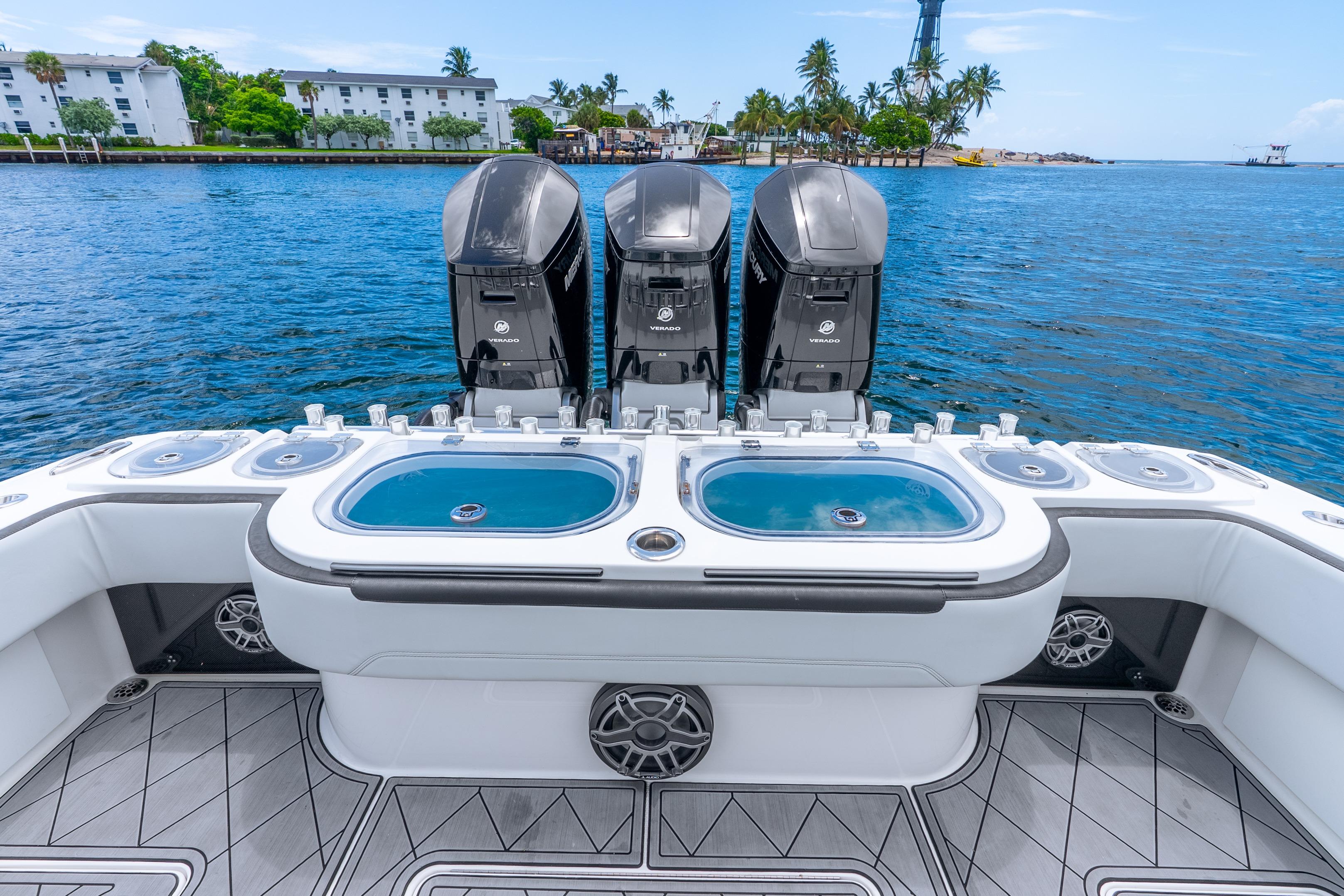 2024 Nor-Tech 452 Super Fish boat with triple outboard engines on a serene waterway.