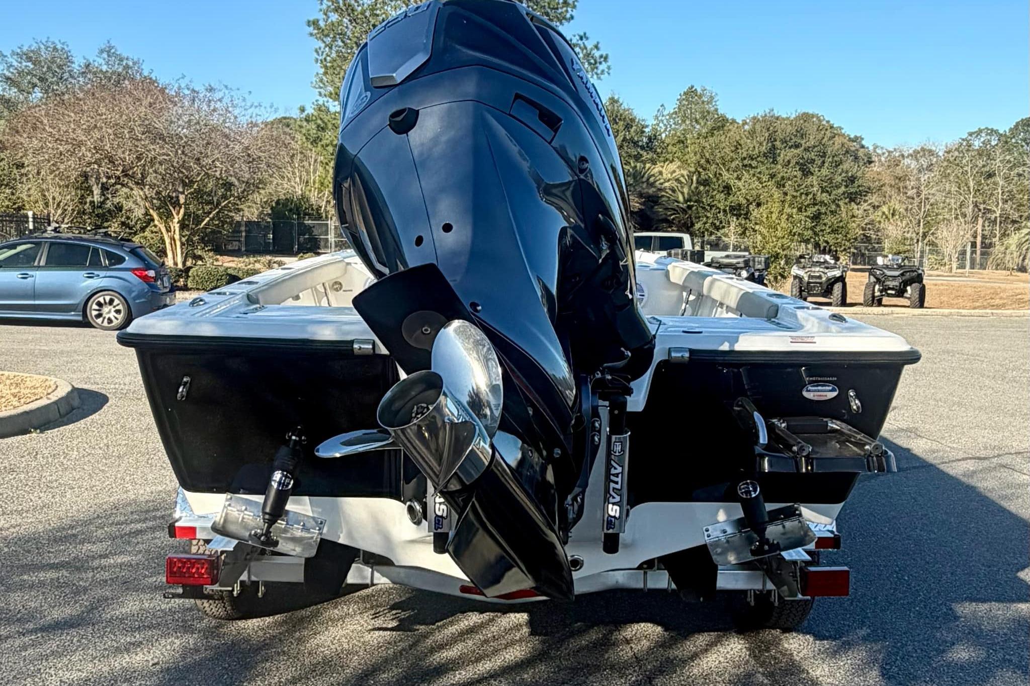 2026 Key West 210 Bay Reef boat with powerful outboard motor in a parking area.