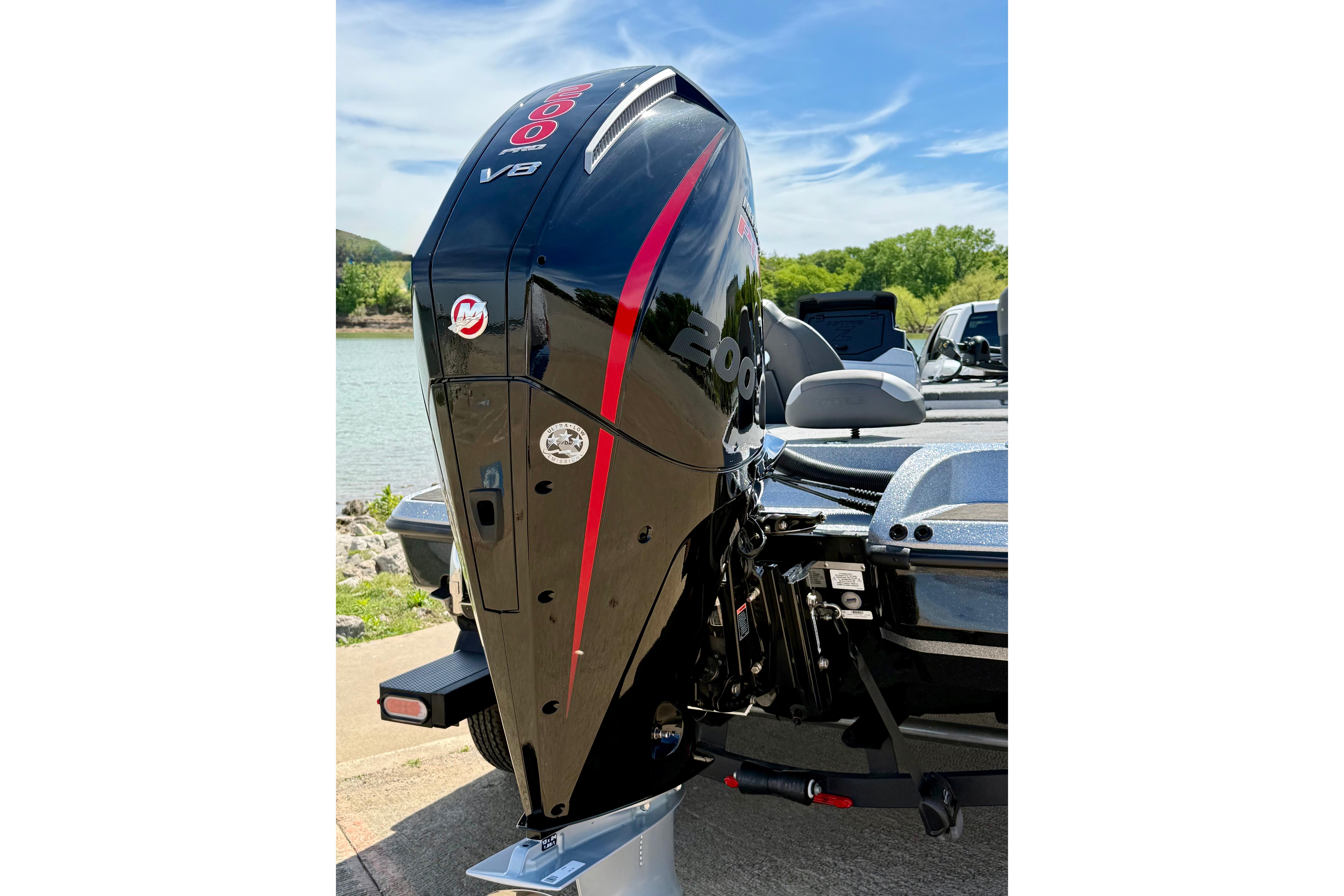2026 Nitro Z19 XL boat with powerful 200 V8 engine, parked by a scenic lake.