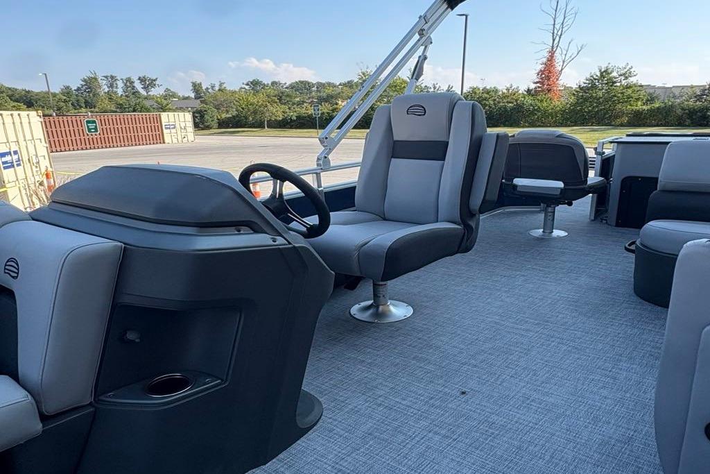 2026 Sun Tracker SportFish 22 DLX pontoon boat interior with modern seating and steering console.