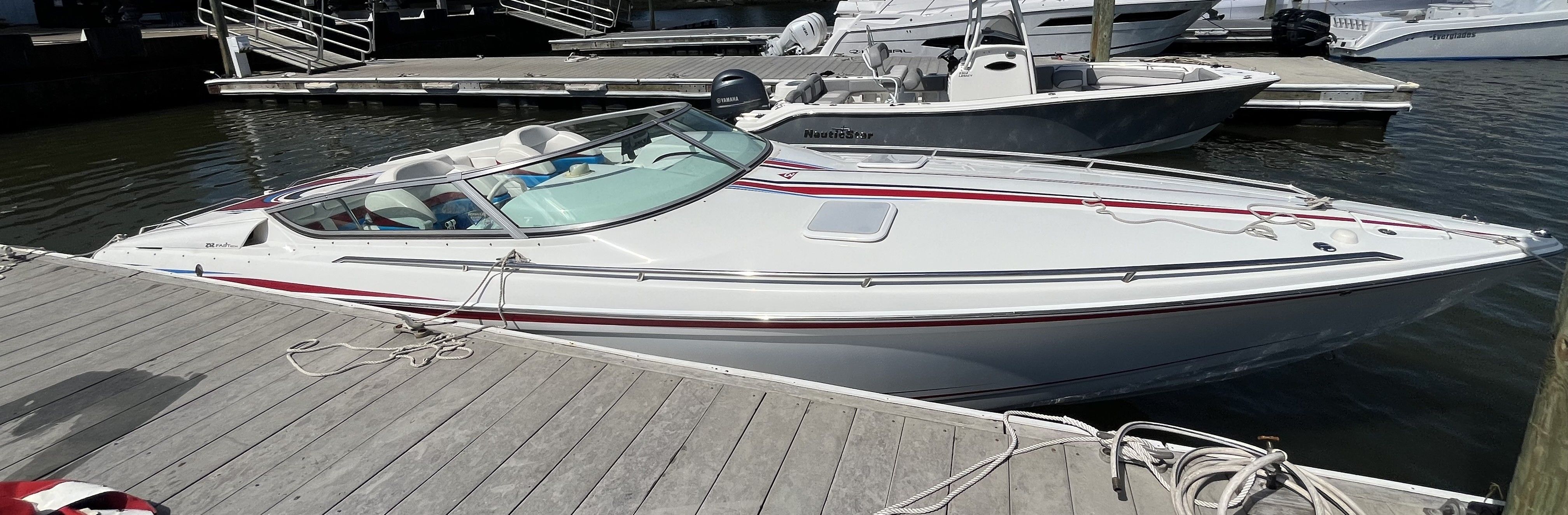 2004 Formula 292 FASTech at the dock with sleek design and red accents.