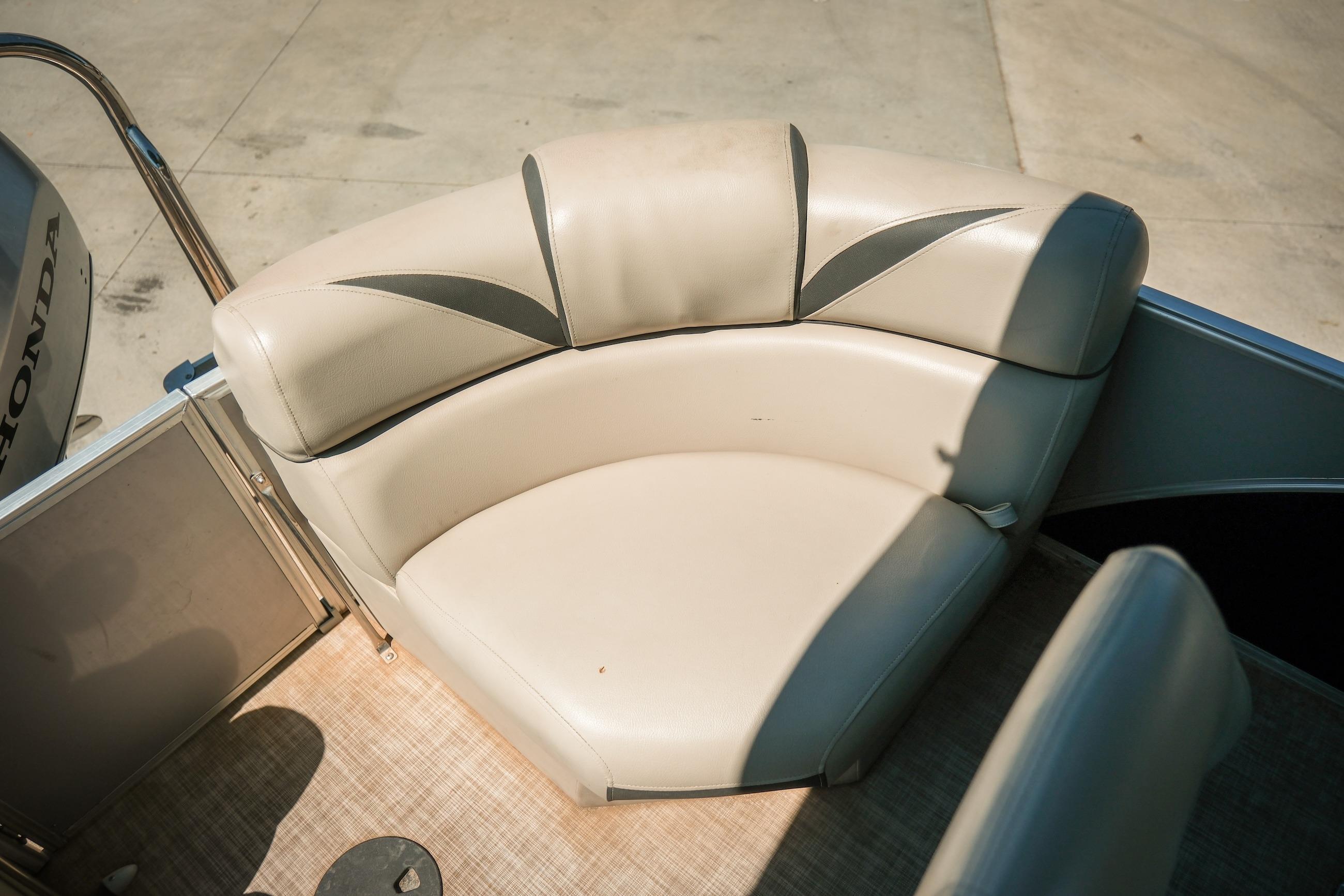 2019 Berkshire 25CLE STS boat seating with beige upholstery and Honda motor detail.