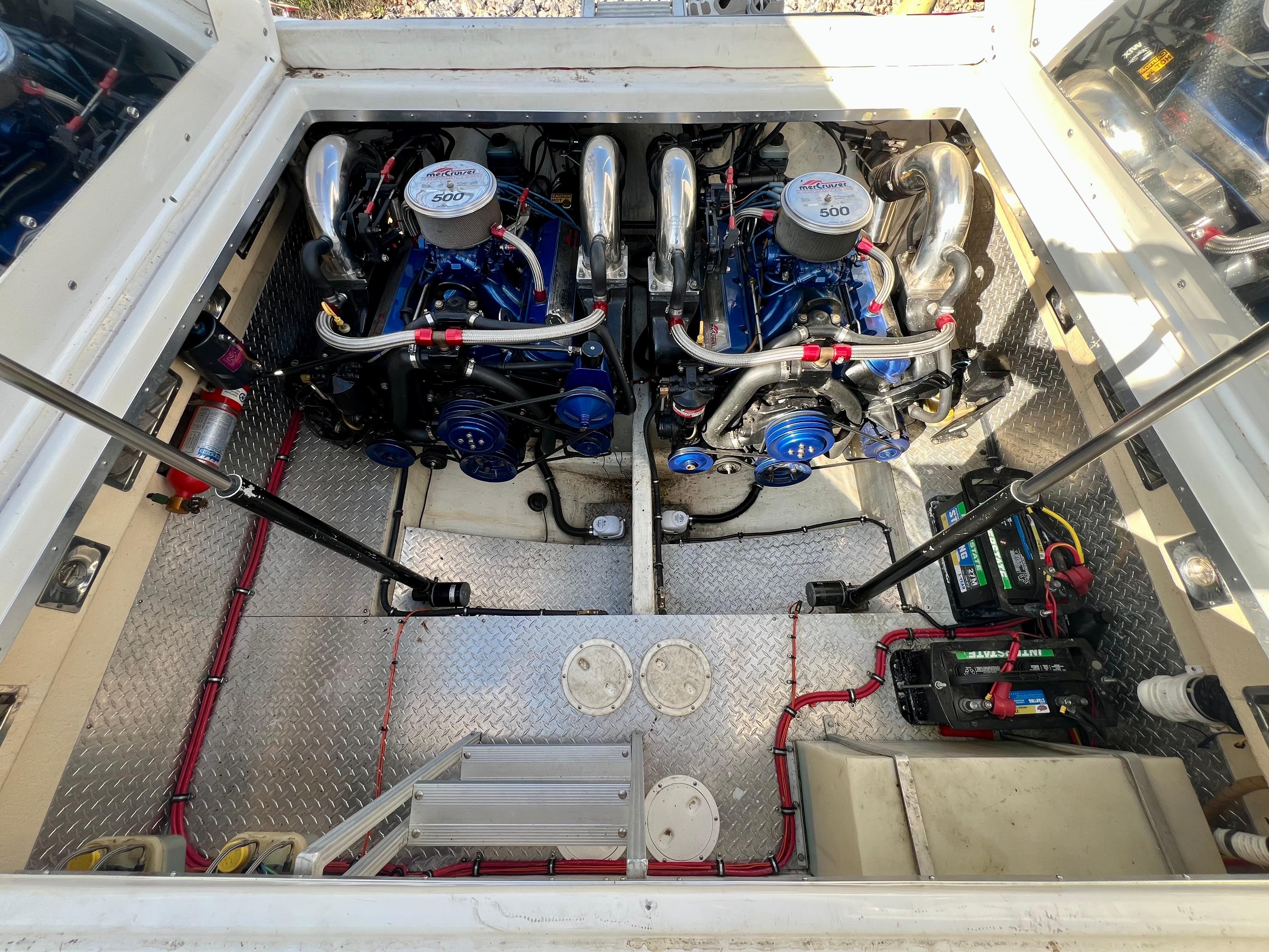 Engine compartment of a 1999 Black Thunder 430 Flat Deck boat, featuring dual engines.
