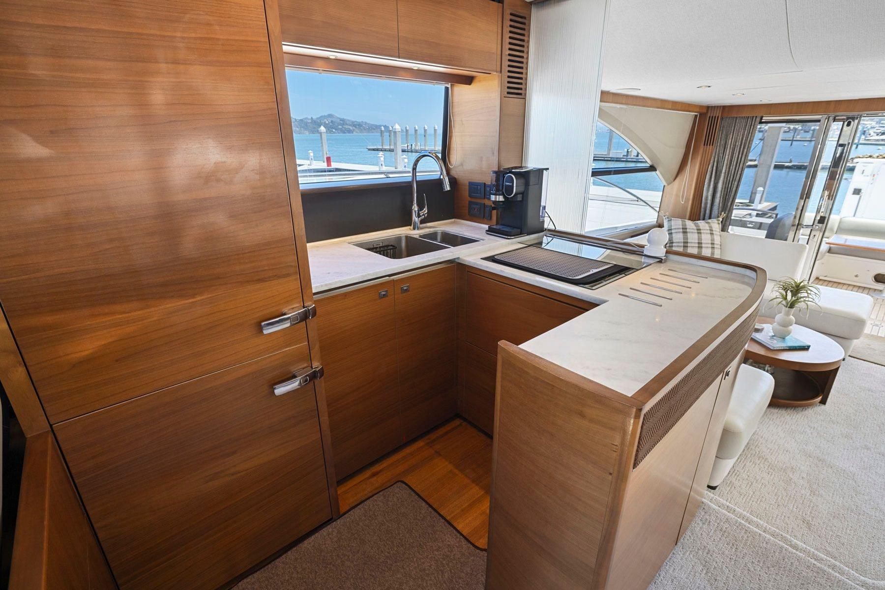 Luxurious kitchen interior of 2015 Princess 60 Flybridge Motor Yacht with modern amenities.