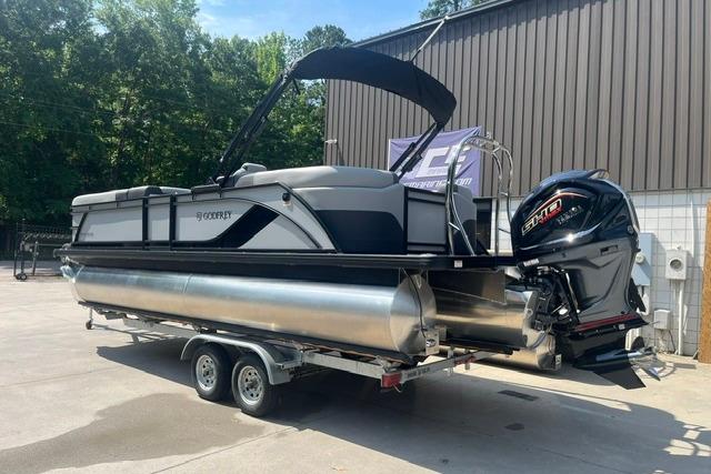 2026 Godfrey Sweetwater 2286 SBC pontoon boat on trailer, parked outdoors.
