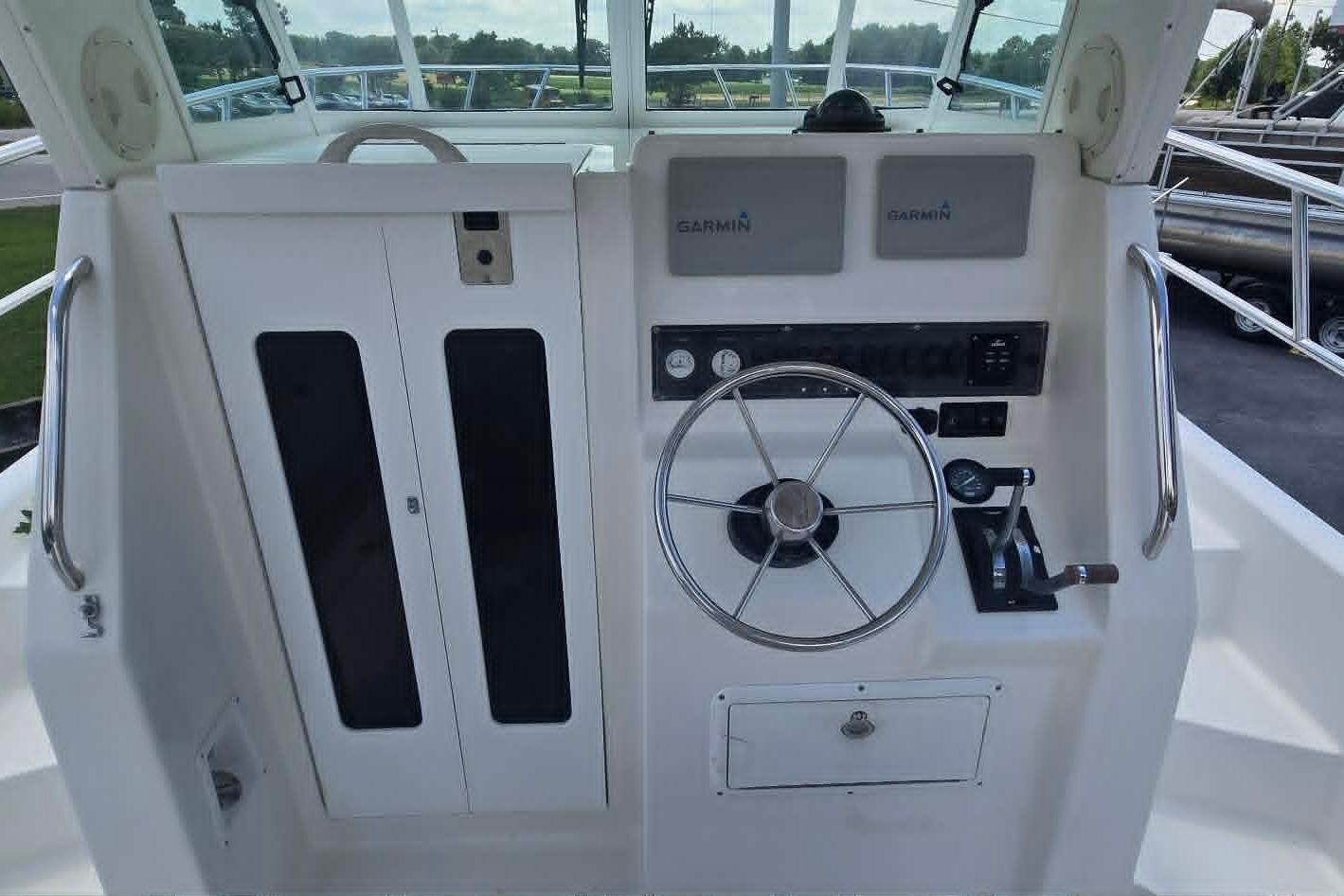 Helm of 2003 True World Marine 286 boat with Garmin navigation equipment.