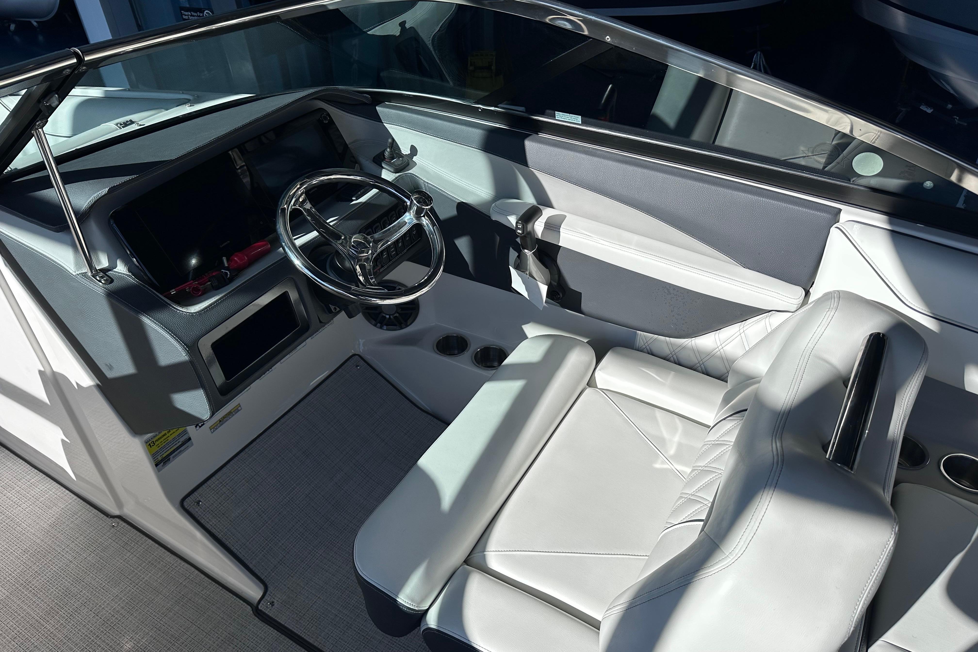 Interior of 2026 Regal LX4 boat with modern steering and white seating.