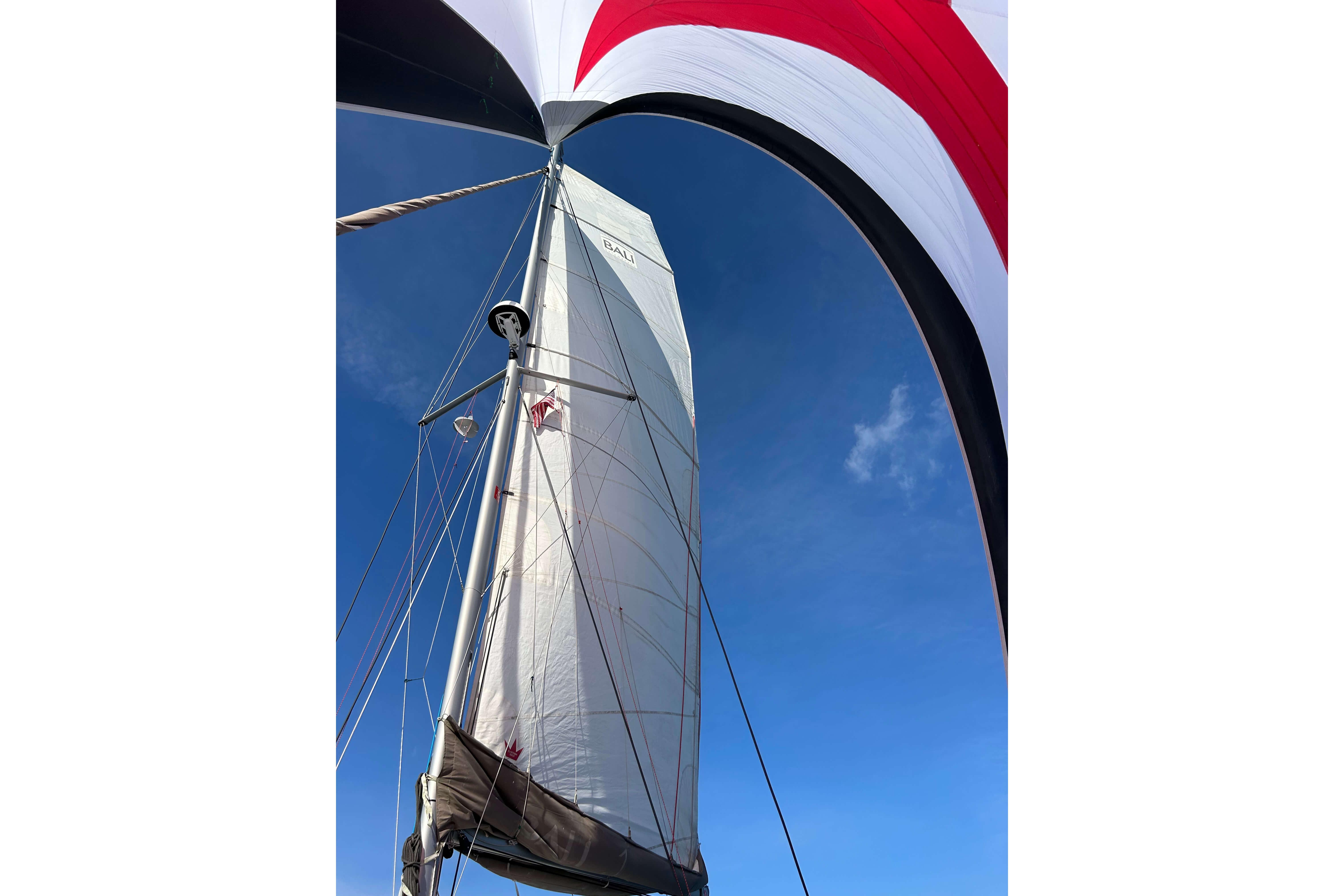 Sailboat mast and sail against clear blue sky, Bali 4.1 model, 2018.