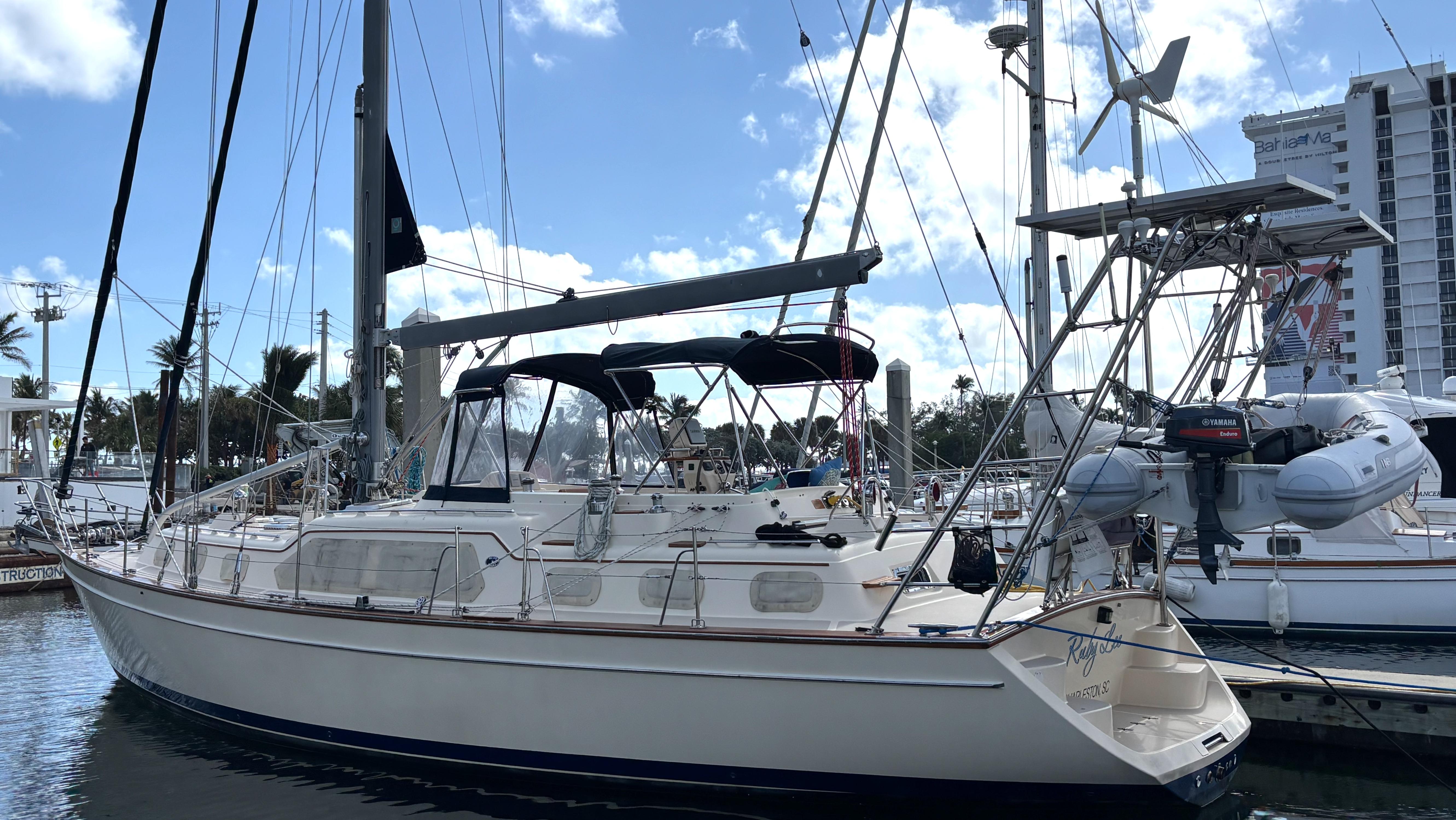 2006 Island Packet 445 sailboat docked in a marina, clear sky background.