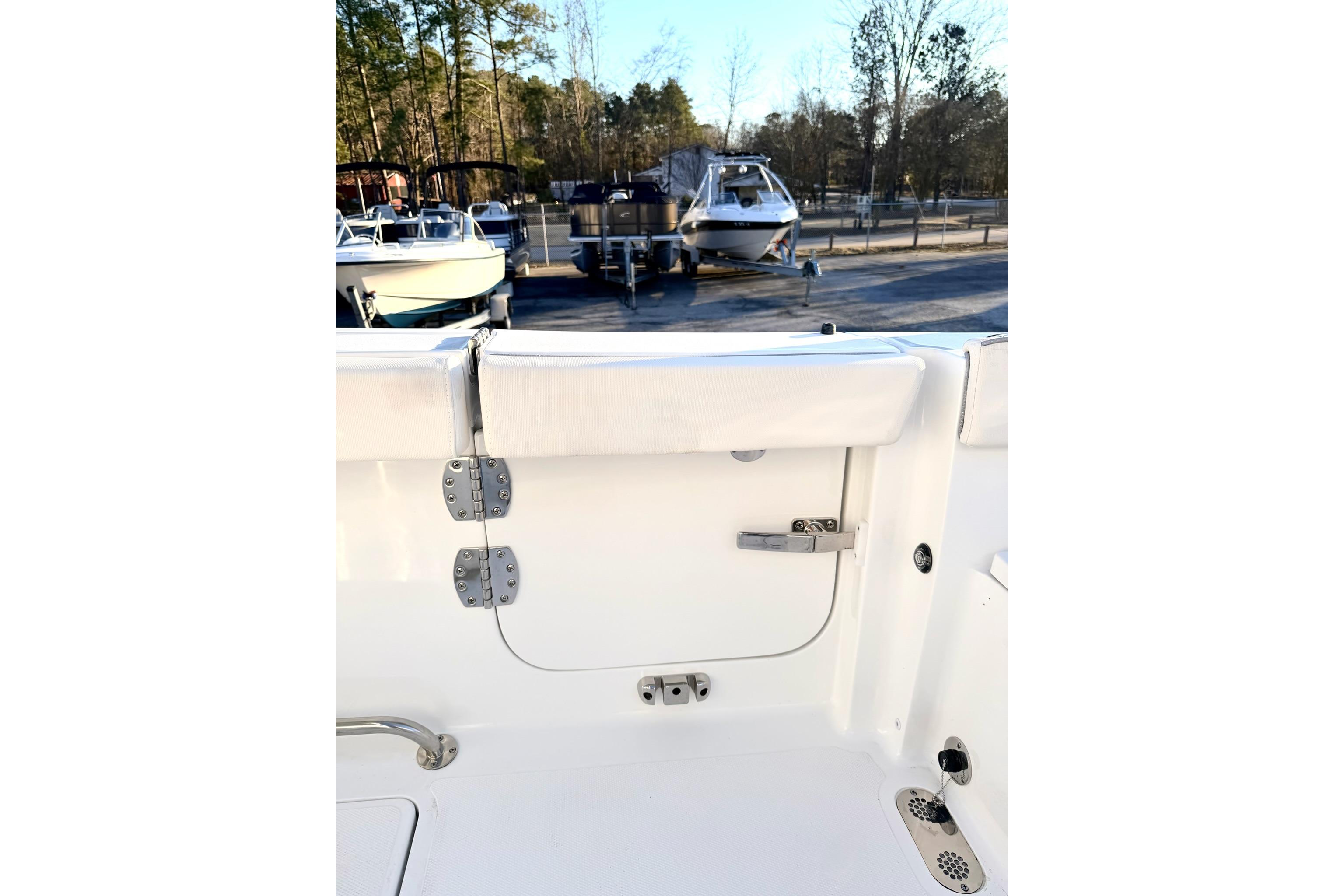 2026 Sea Hunt Ultra 275 Coffin Box interior with white seating and storage compartment.
