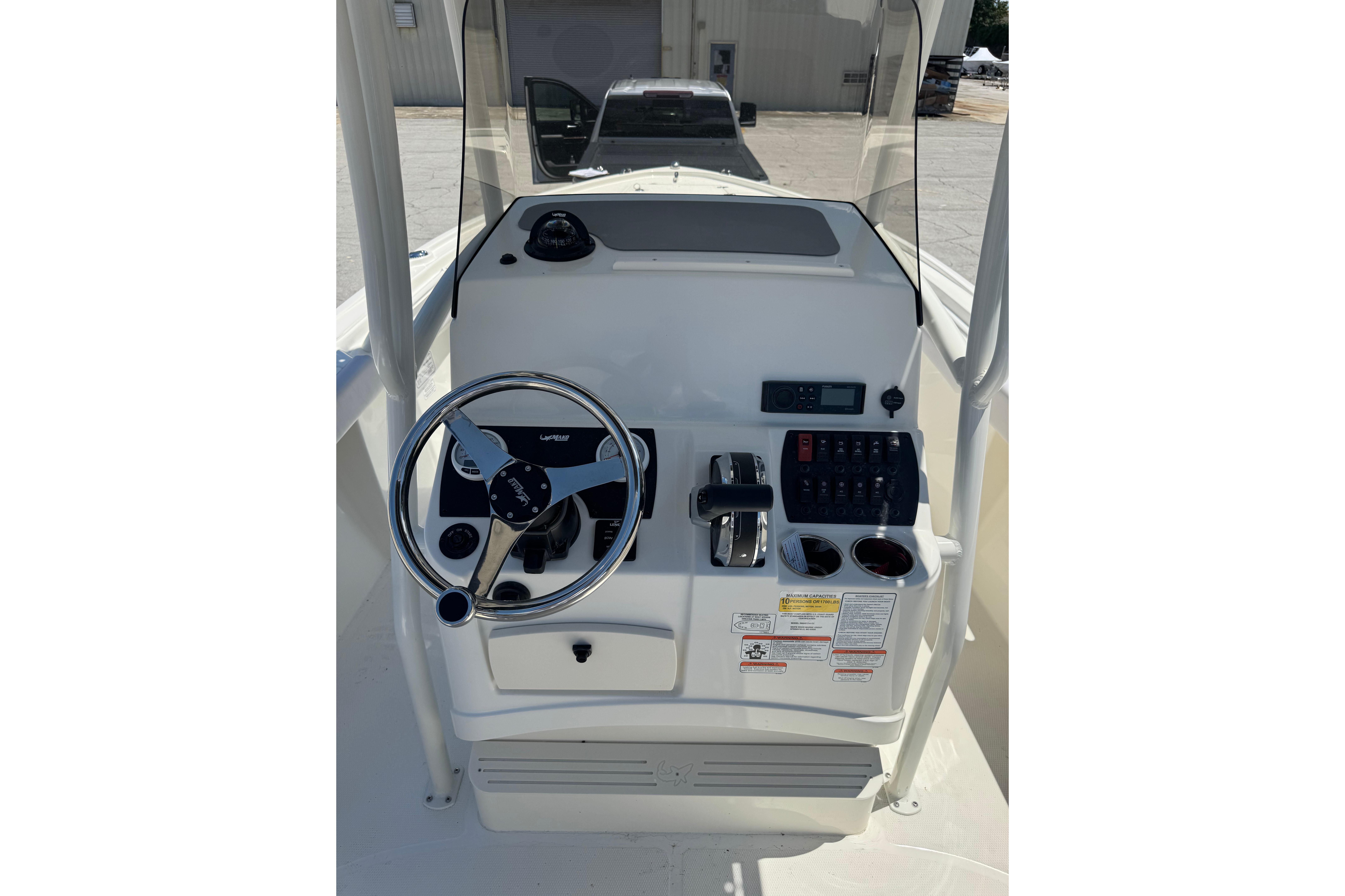 Center console of 2026 Mako 214 boat with steering wheel and controls.