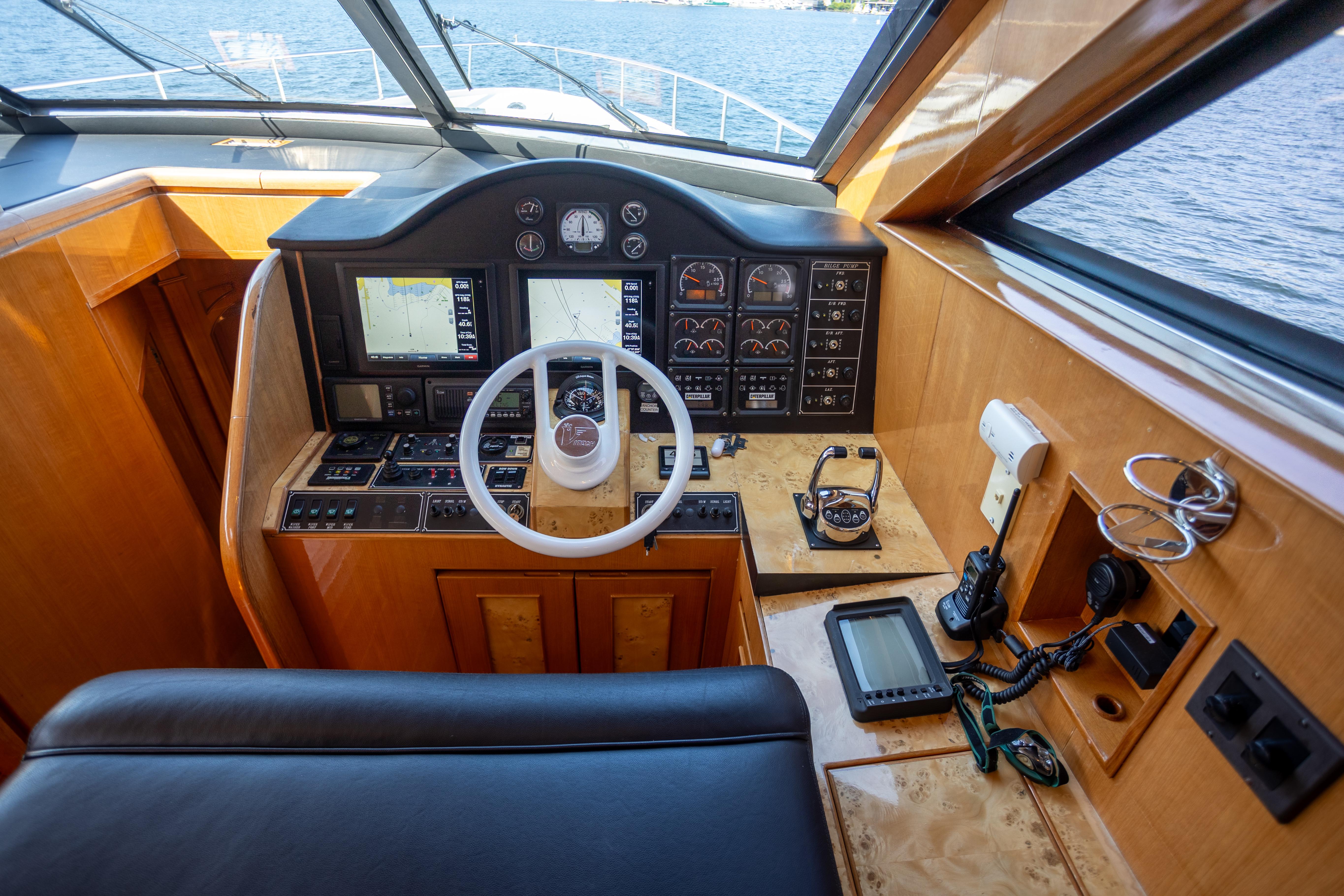 Cockpit of 2001 Vitech 72 yacht with navigation instruments and steering wheel.