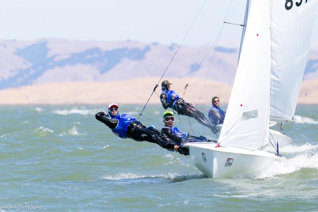 Sailors racing on a 2025 One Design ZIM Club 420 sailboat in windy conditions.