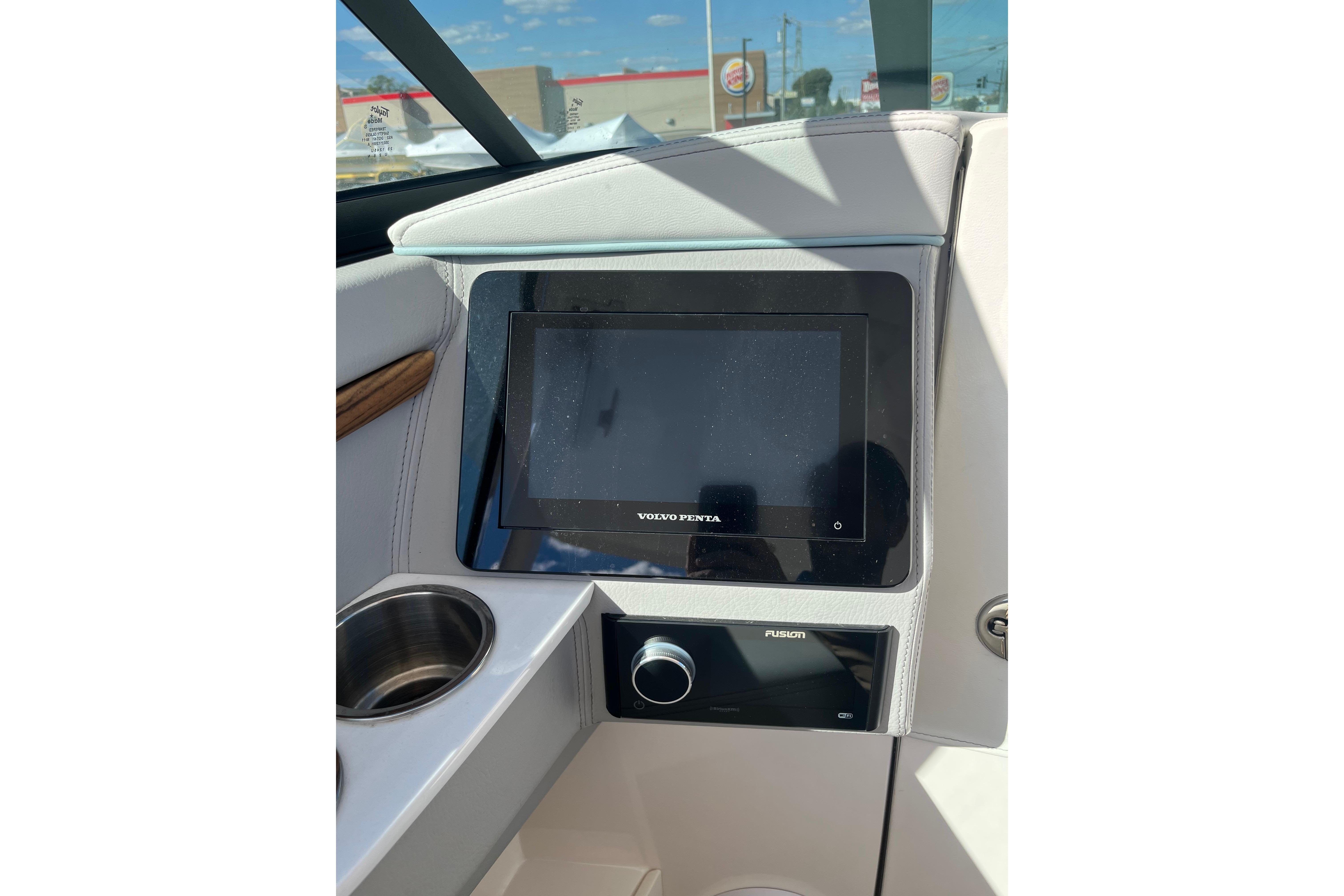 2024 Regal LS9 Surf boat dashboard with Volvo Penta display and Fusion audio system.