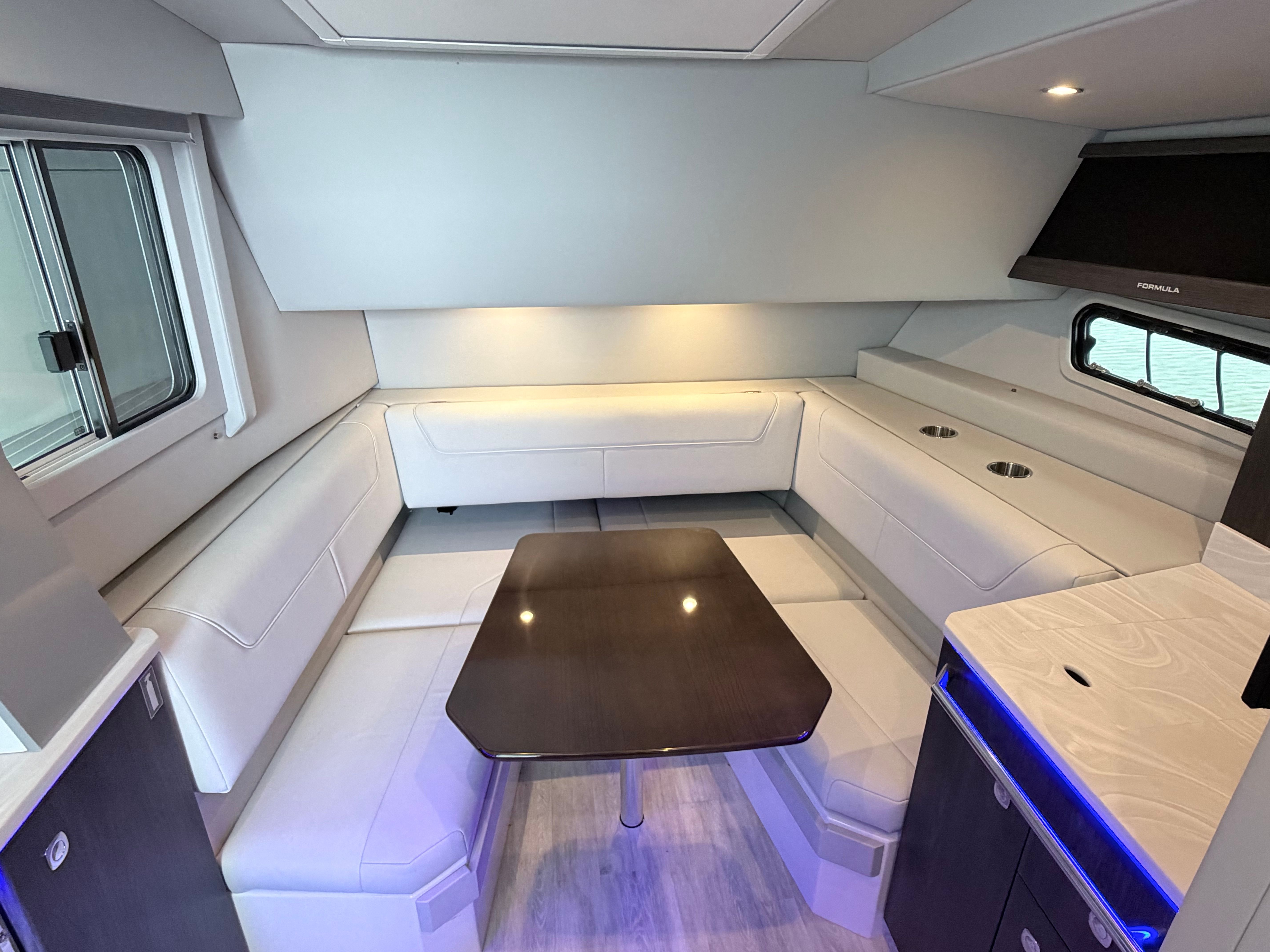 Interior of the 2023 Formula 400 Super Sport Crossover with elegant seating area and table.