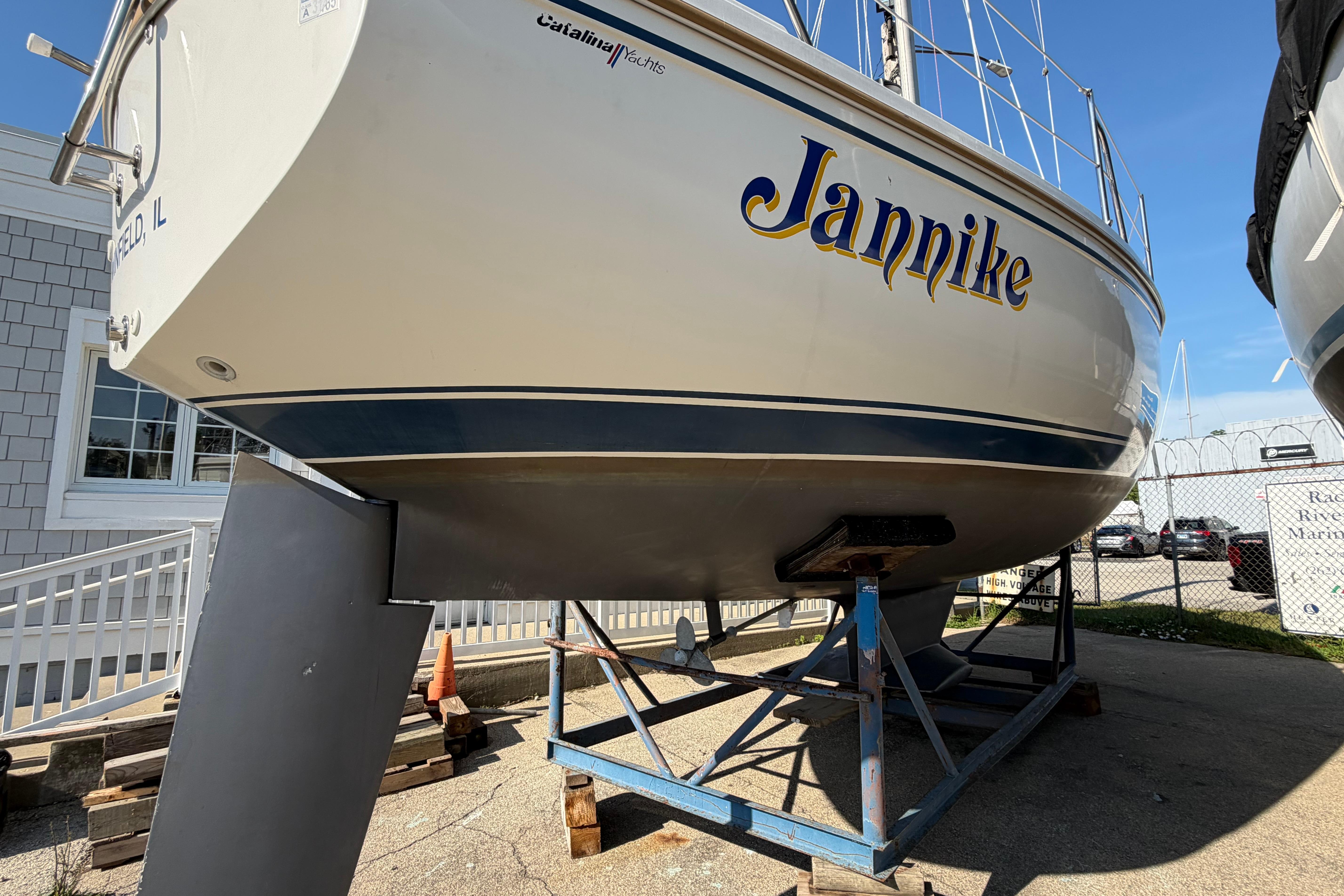 Catalina 30 MkII sailboat from 1988 named "Jannike" on a stand in a marina.