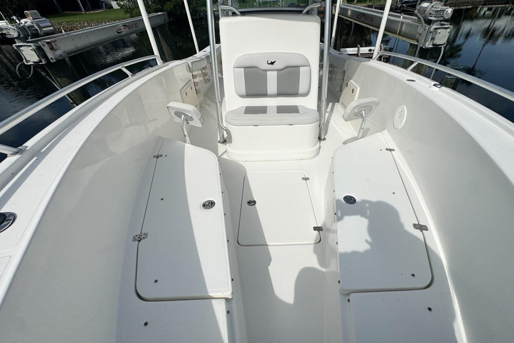 2018 Mako 284 Center Console boat interior with seating and storage compartments.