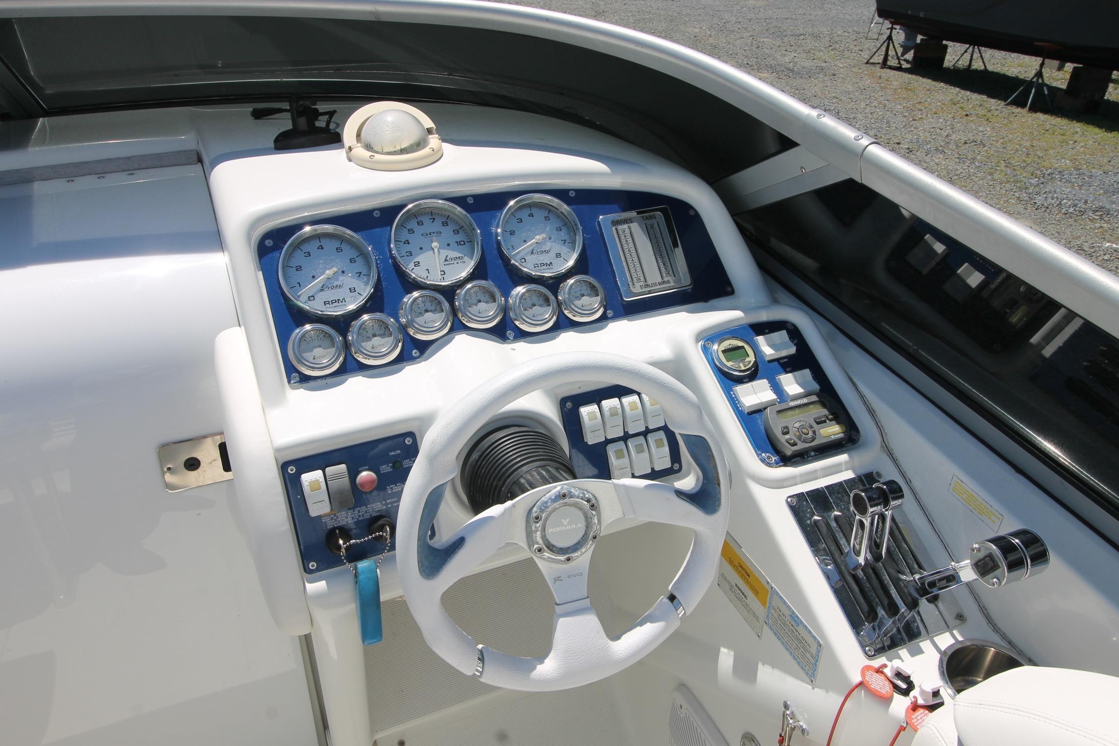 2006 Formula 292 FASTech boat dashboard with gauges and steering wheel.