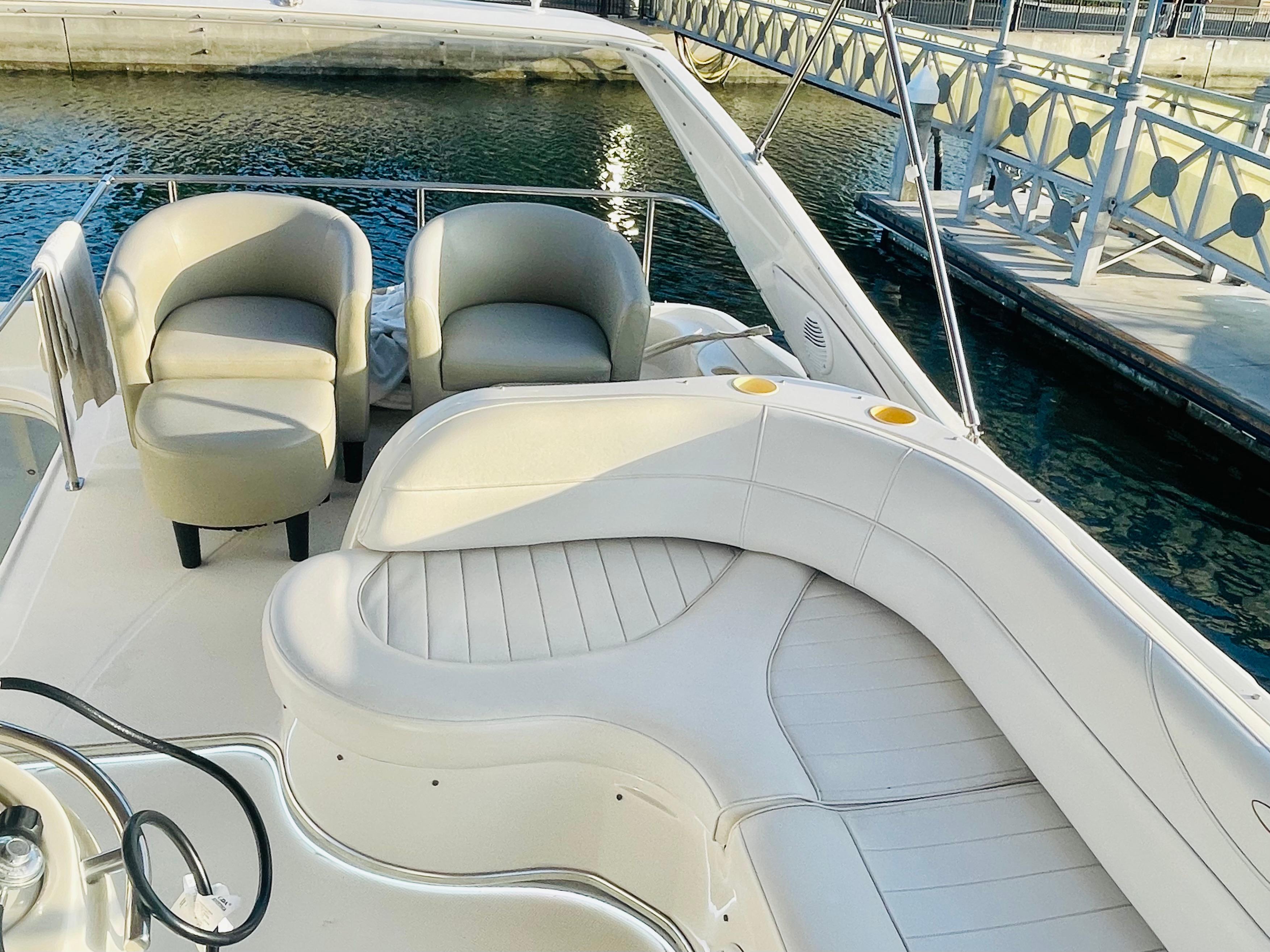 1998 Maxum 4100 SCA yacht with elegant seating, docked by the water.