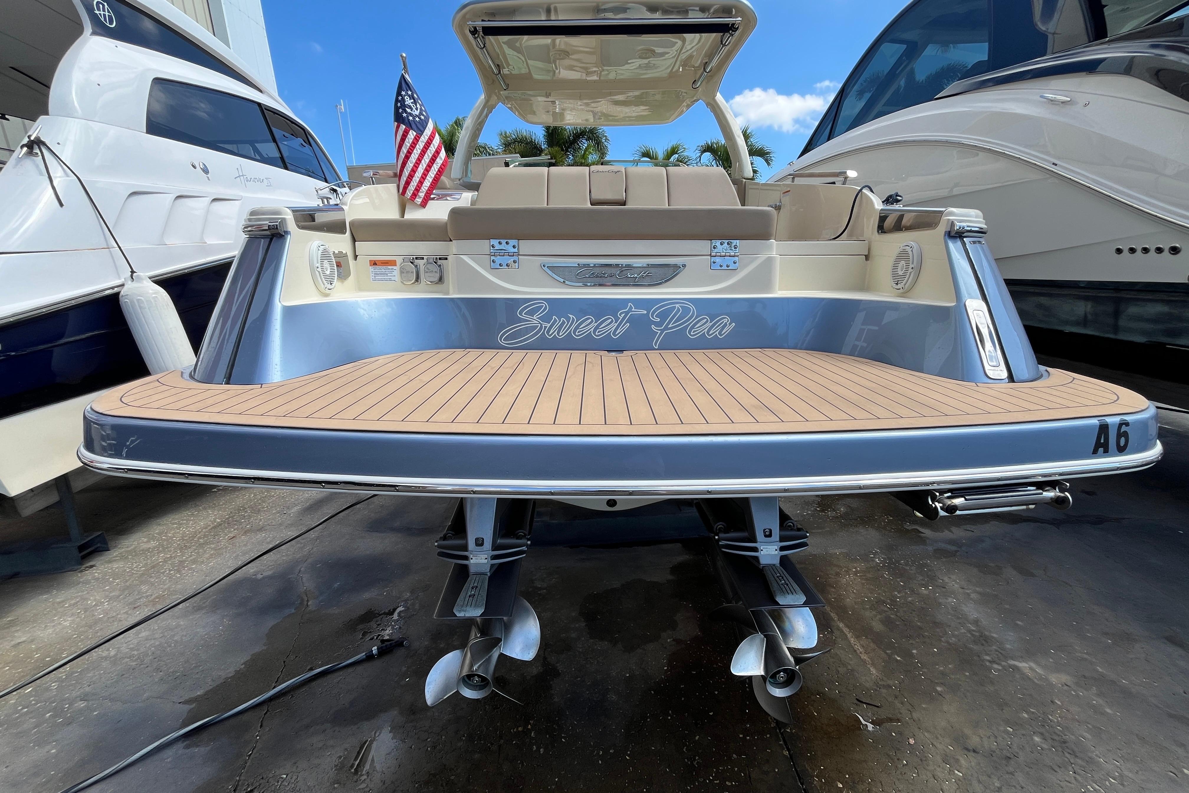 2022 Chris-Craft Launch 35 GT I/O boat with teak deck and American flag.