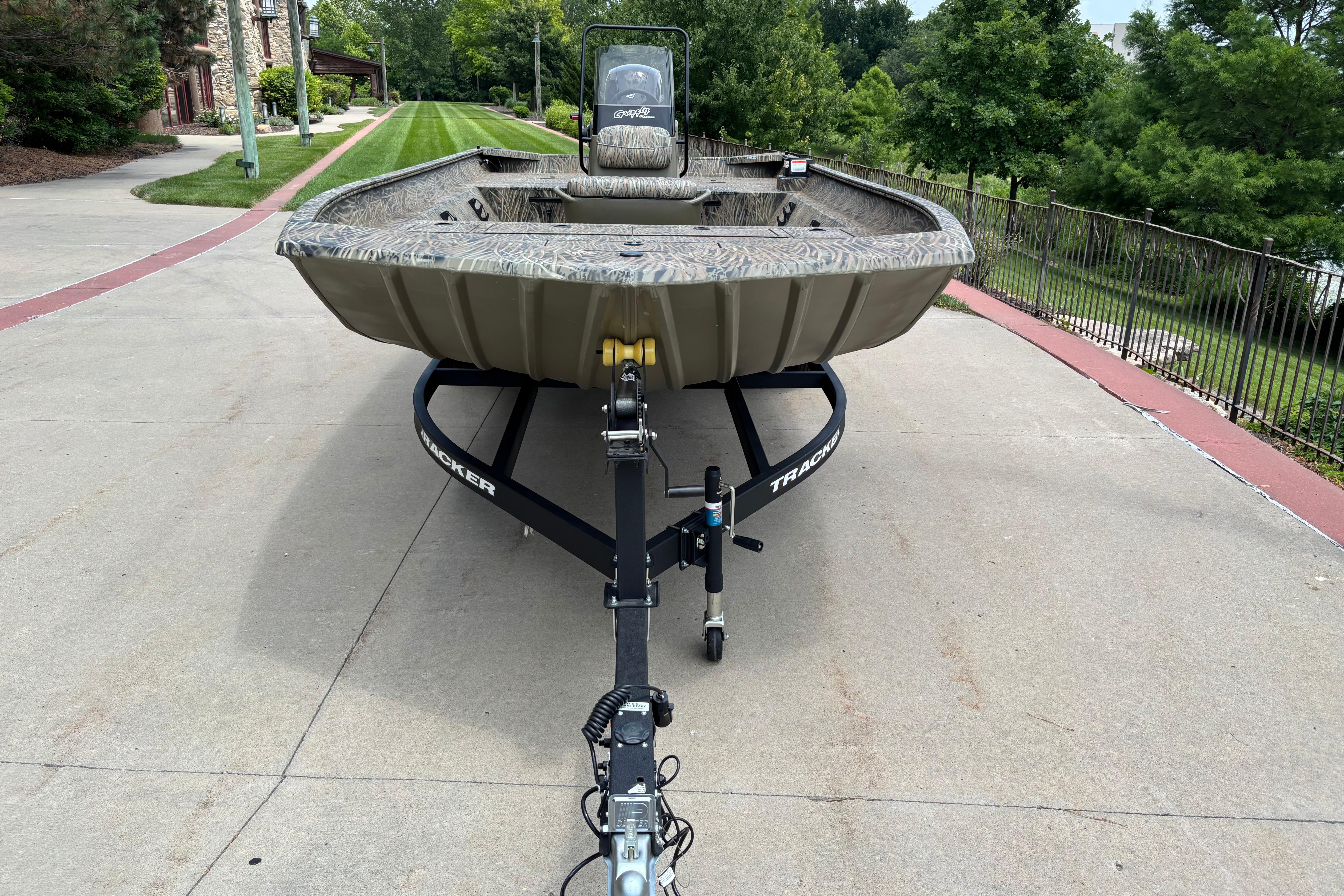 2026 Tracker Grizzly 2072 CC boat on trailer, parked on a driveway.