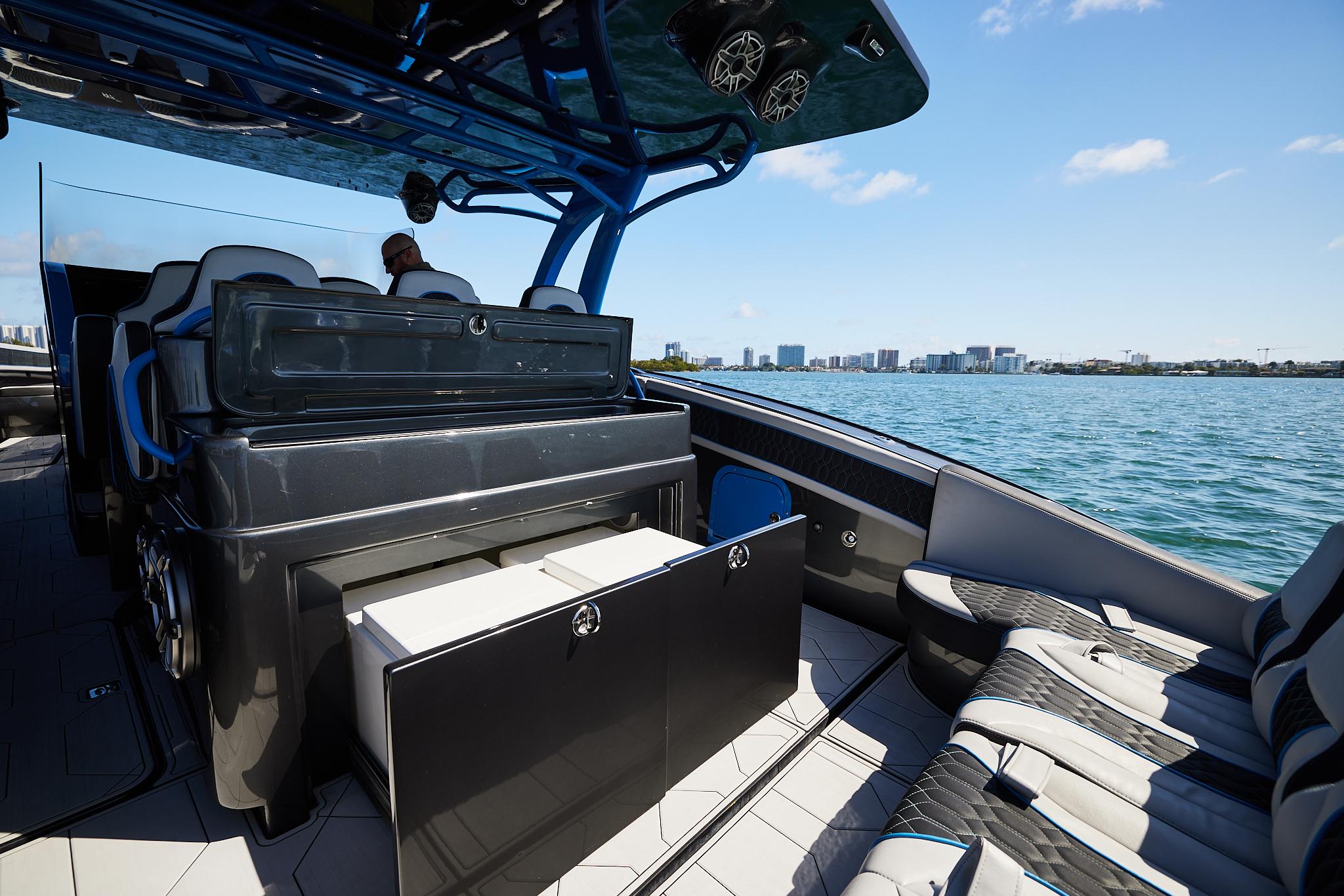 2023 Midnight Express 43' Solstice luxury boat interior with seating, ocean view, and city skyline.